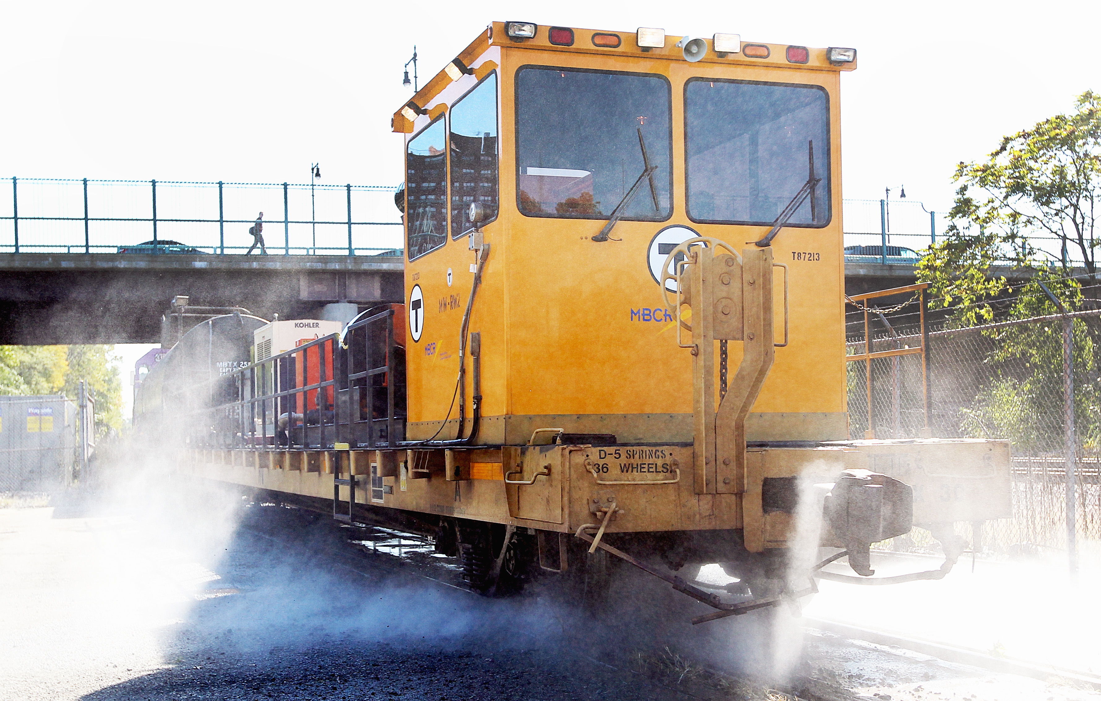 A power washer cleans the leaf slick rails.