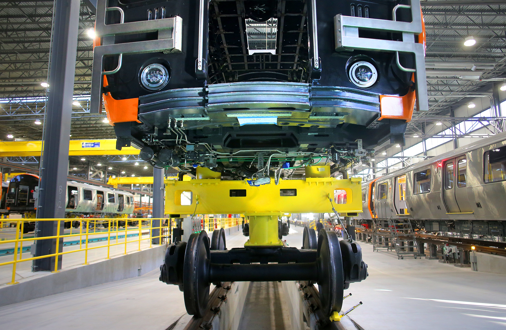 New Orange Line cars sat on the production floor of the factory.