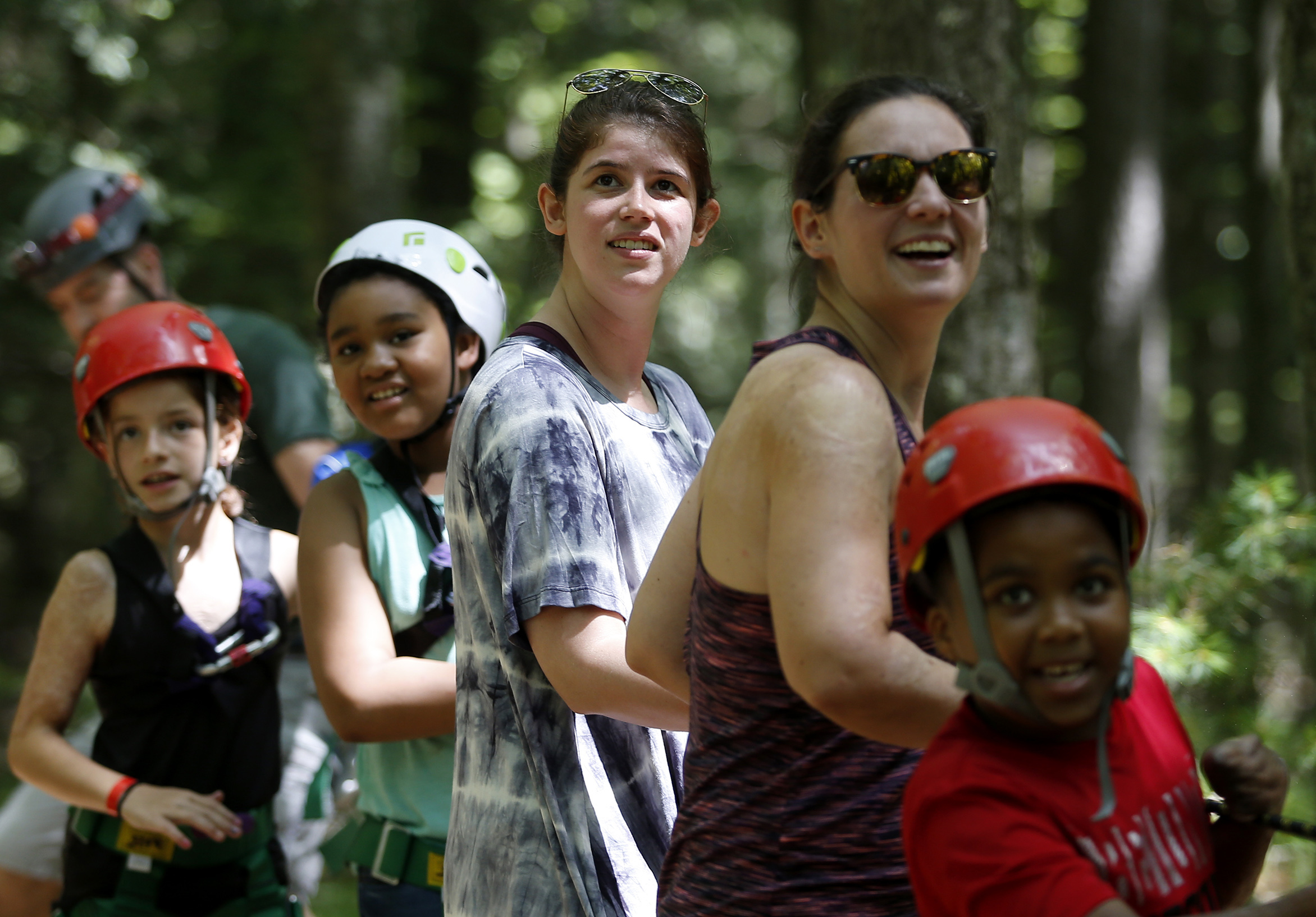 Counselor Kelsey Pandiani (center) helped to haul a camper up onto the swing shot. Kelsey was badly burned as a child and sees herself in the campers.