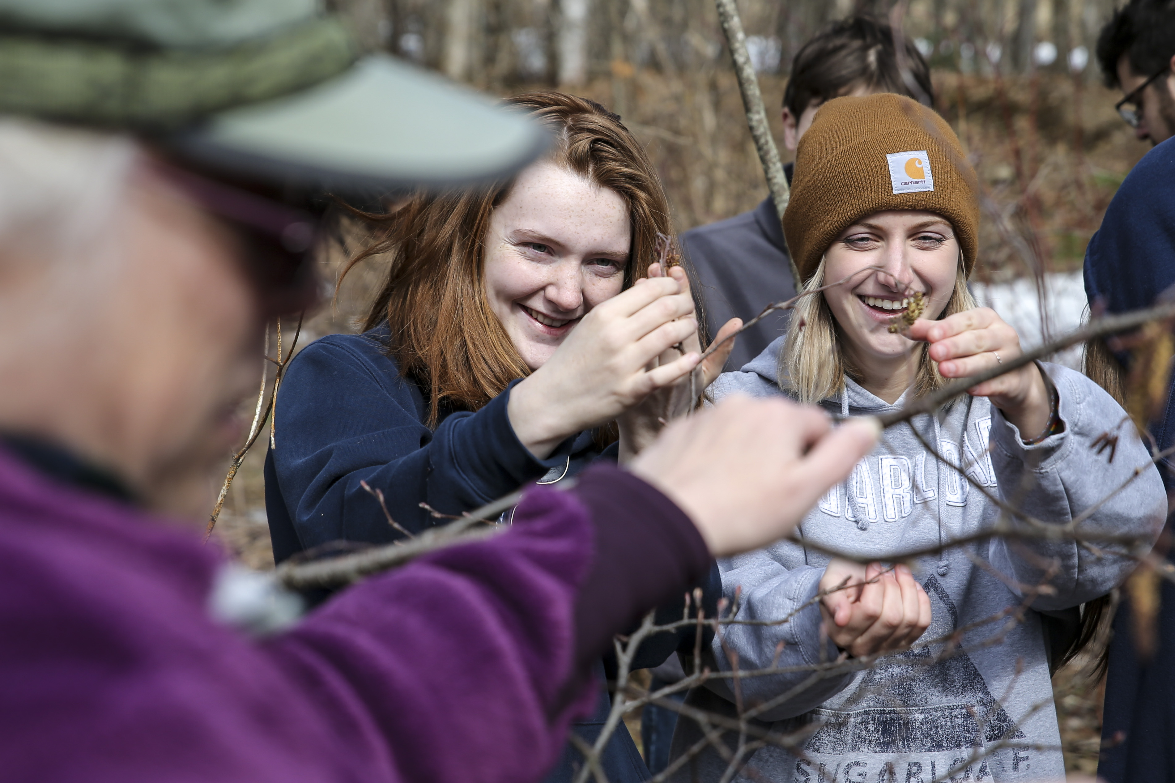 Madelyn Battock-Emerson (center) and Alyssa Abbotoni (right) inspected flora during a plant biology outdoor lab.