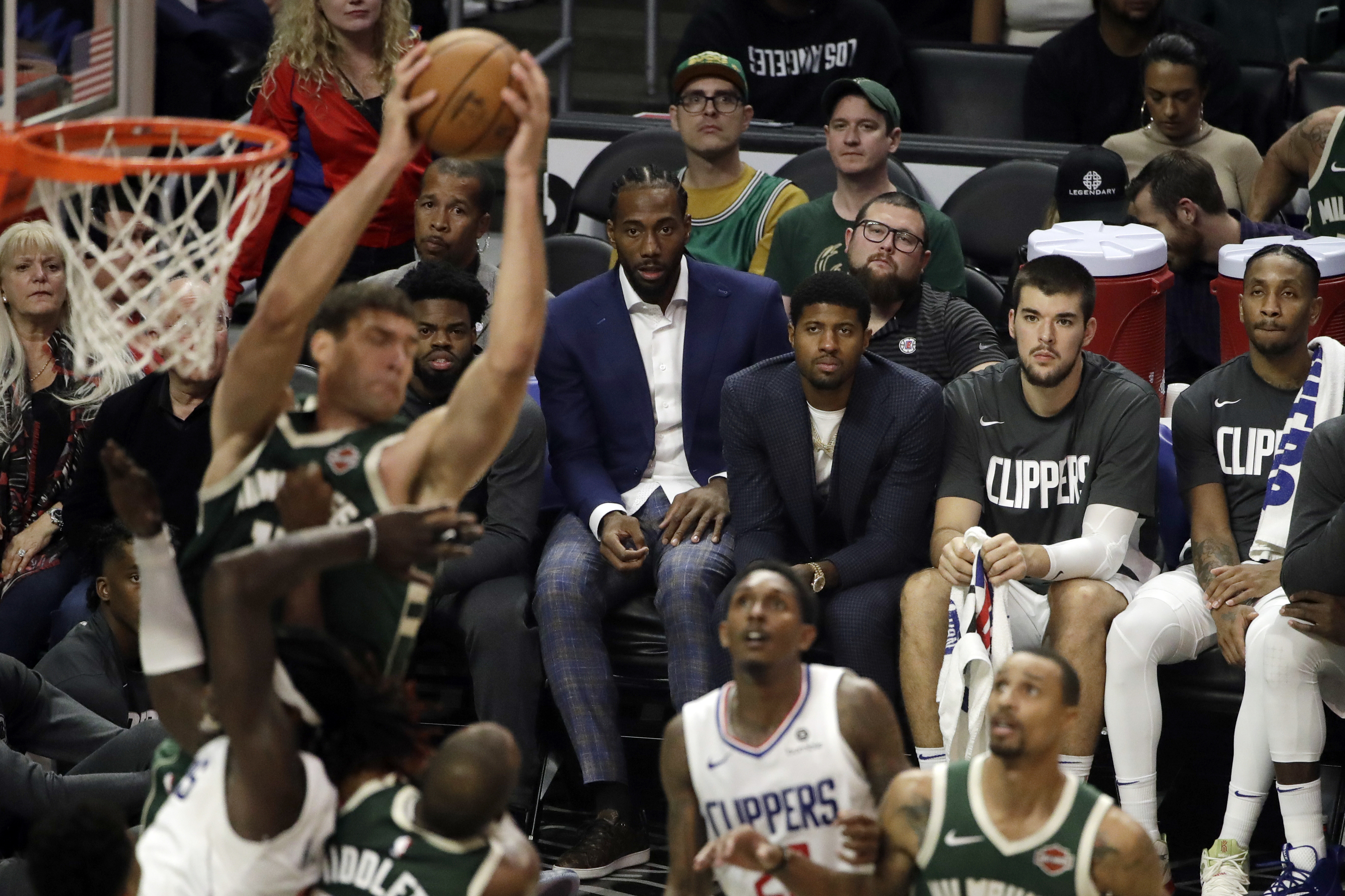 The Clippers’ Kawhi Leonard and Paul George watched Wednesday’s game against the Bucks from the bench due to injuries.