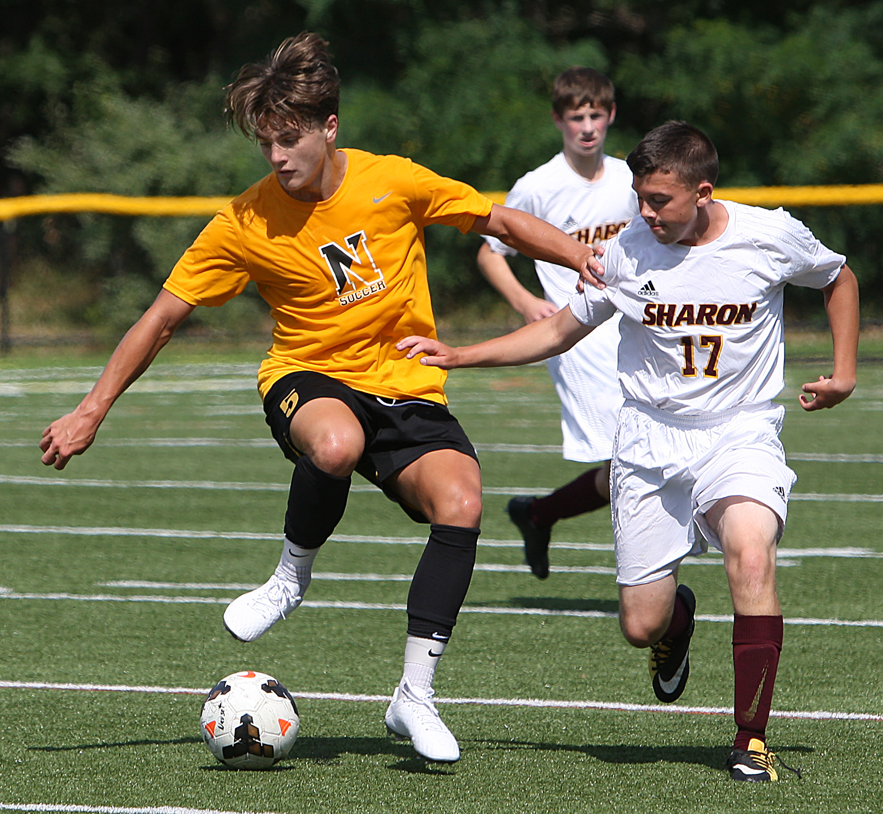 Nauset senior captain Sean Headrick (5), controls the ball against Sharon’s Andrew Garcia (17) during a preseason matchup, displays the technique he and his teammates have honed by playing year round.