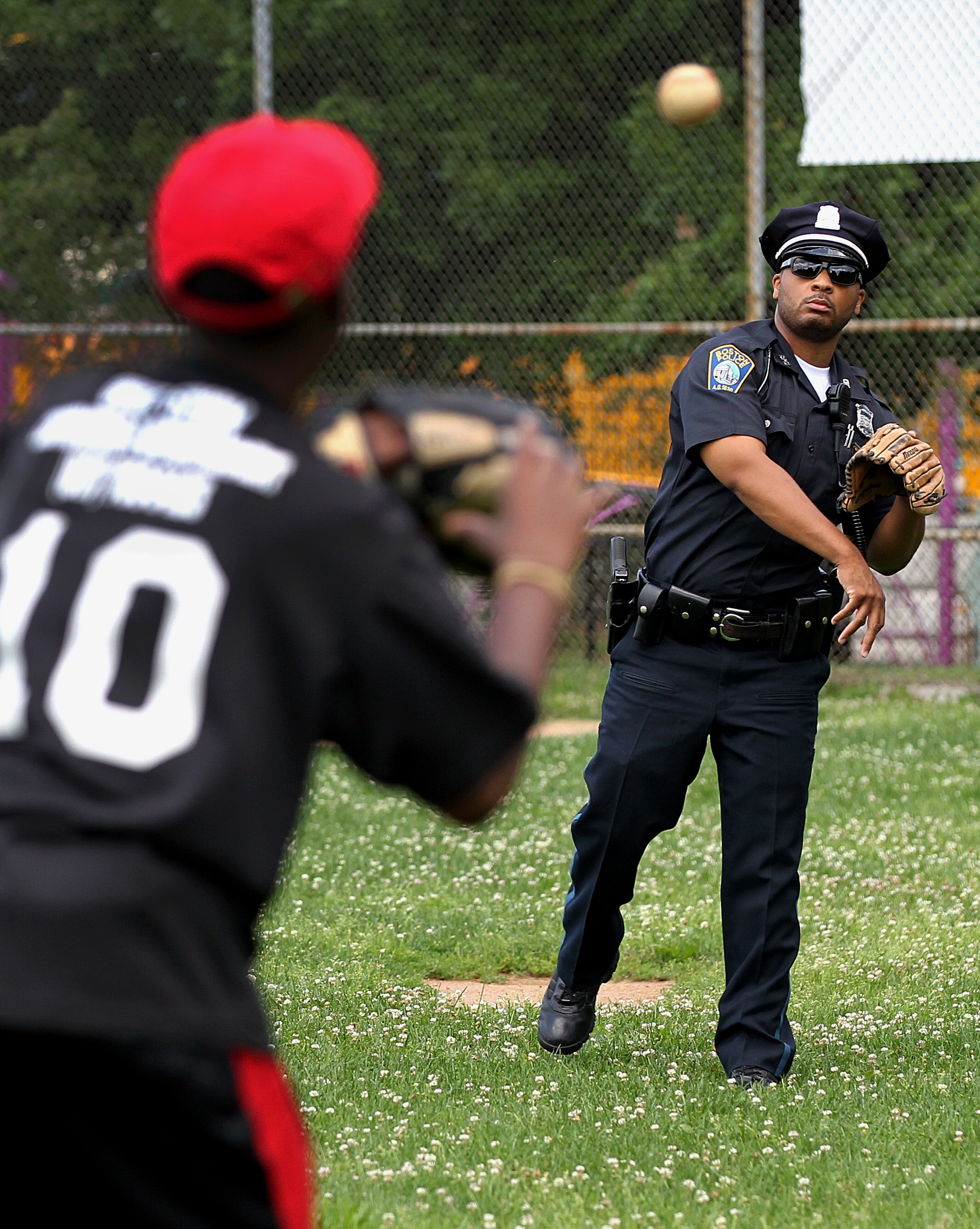 Simmonds played catch with a Little League ballplayer before the start of a game at Harambee Park in Dorchester.