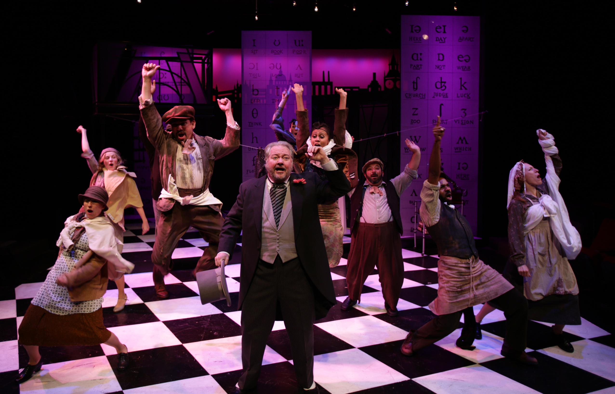 J.T. Turner (center) and cast in Lyric Stage Company’s production of “My Fair Lady.”