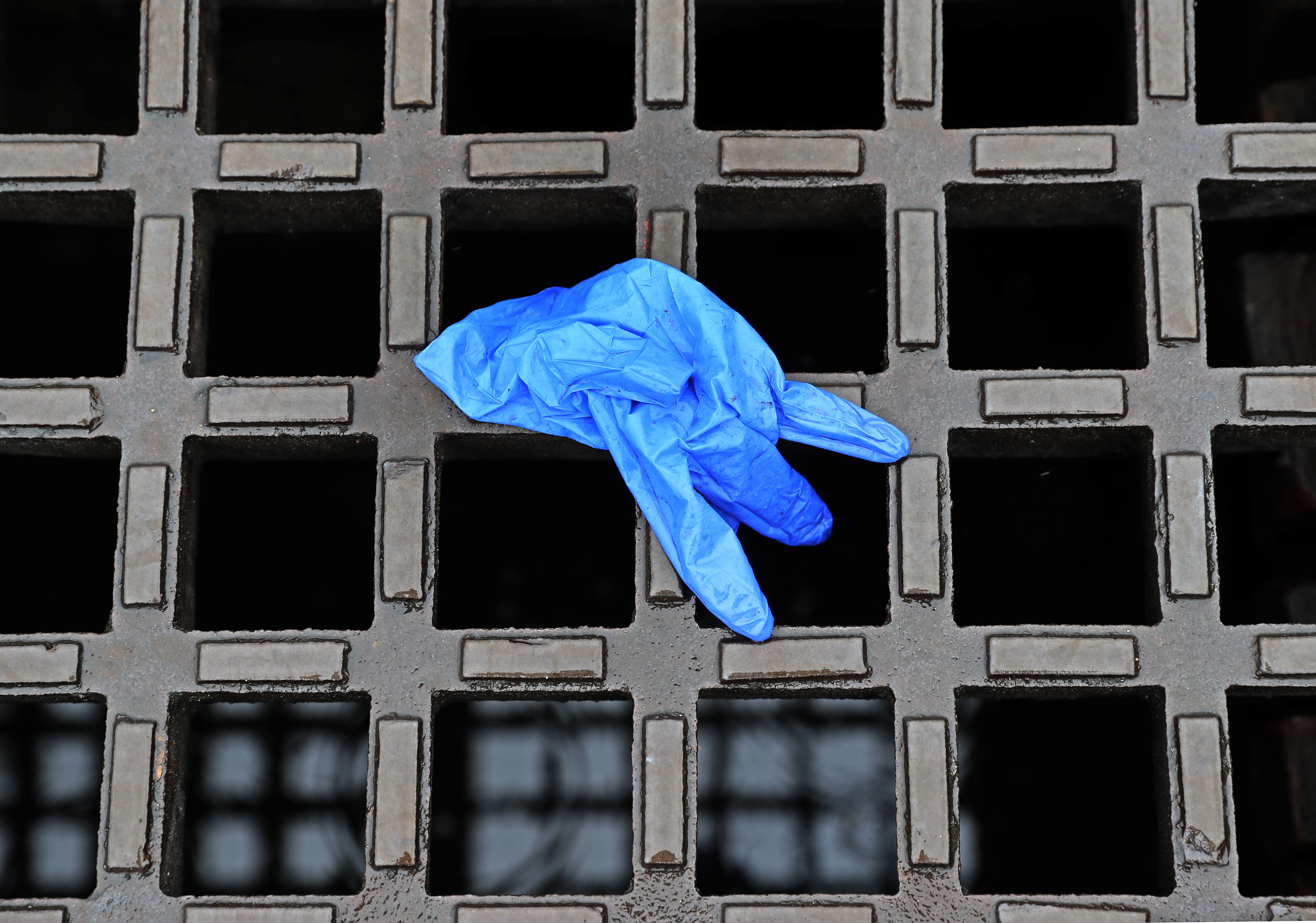 A glove on a street gutter in Boston.