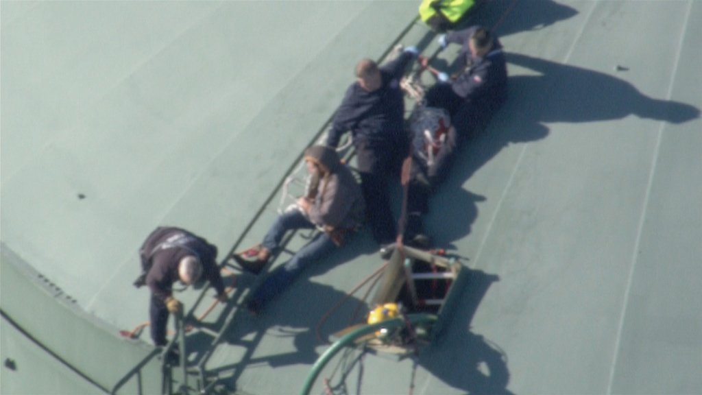 Firefighters worked to rescue two workers who became trapped inside a large water tank Thursday morning.