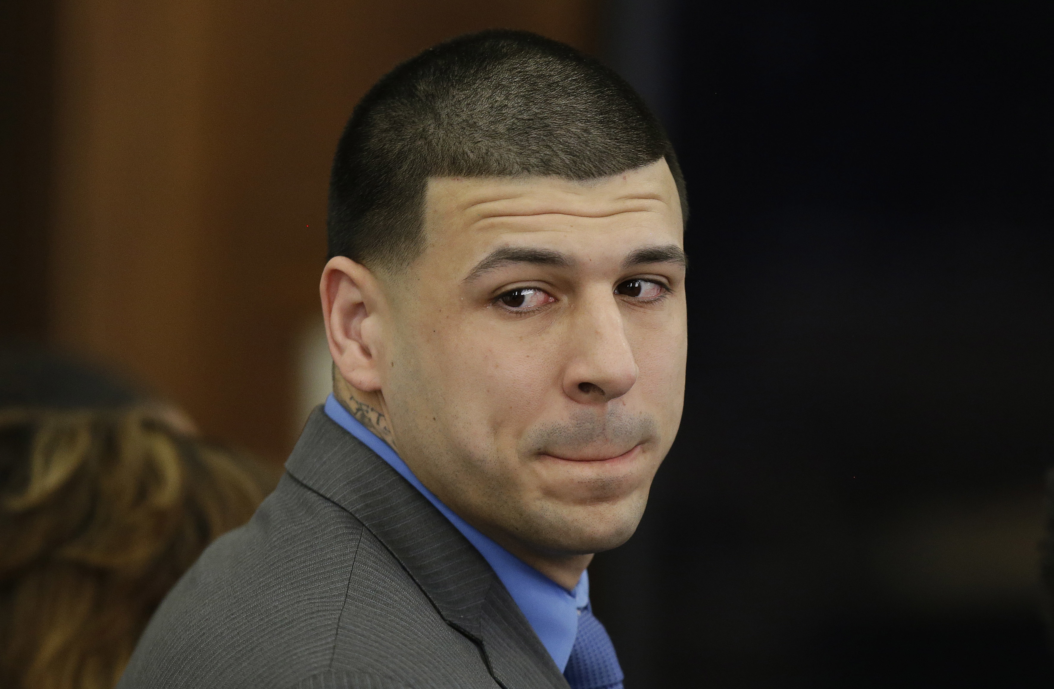 Former New England Patriots tight end Aaron Hernandez turned to look in the direction of the jury as he reacted to his double murder acquittal on Friday.
