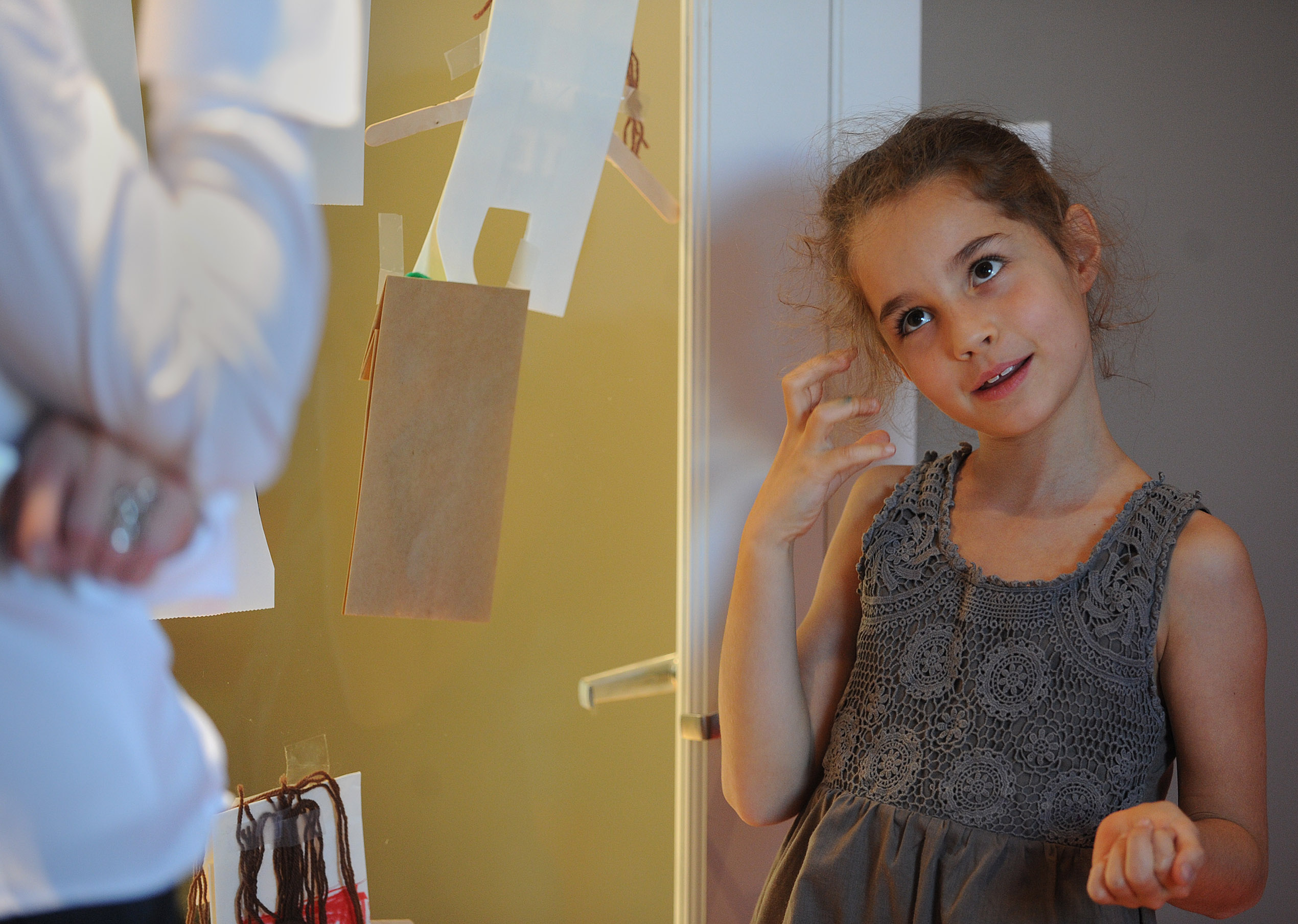 Zara Ceraj, 7, uses a pretend phone as she demonstrates how to answer a call in an Etiquette Academy of New England children’s class in Brookline.