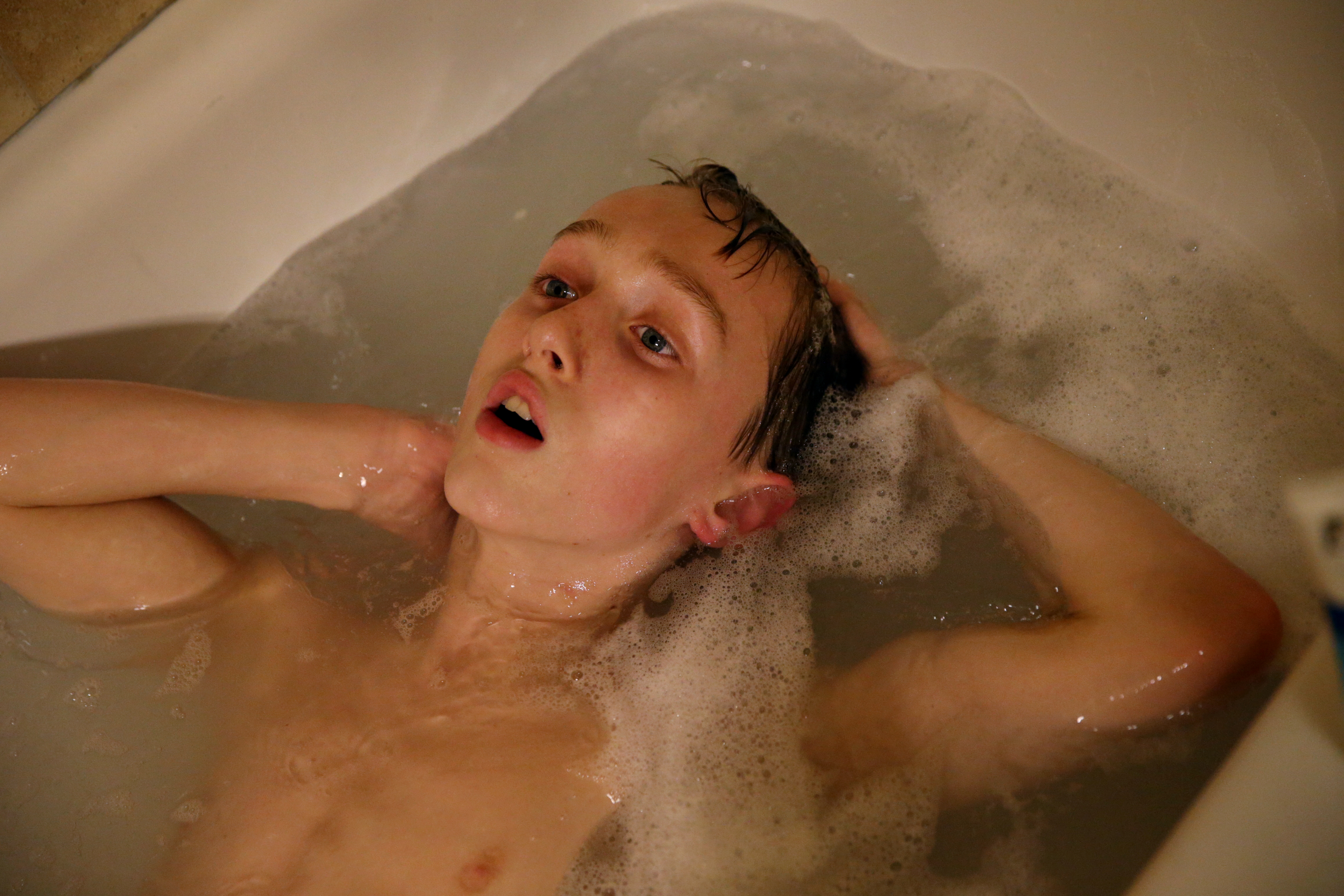 Connor soaked in the bathtub. He has been diagnosed with autism, a mood disorder, and attention deficit hyperactivity disorder. As many as half of children with autism also have a mental health disorder, and the combination makes treatment more complicated.