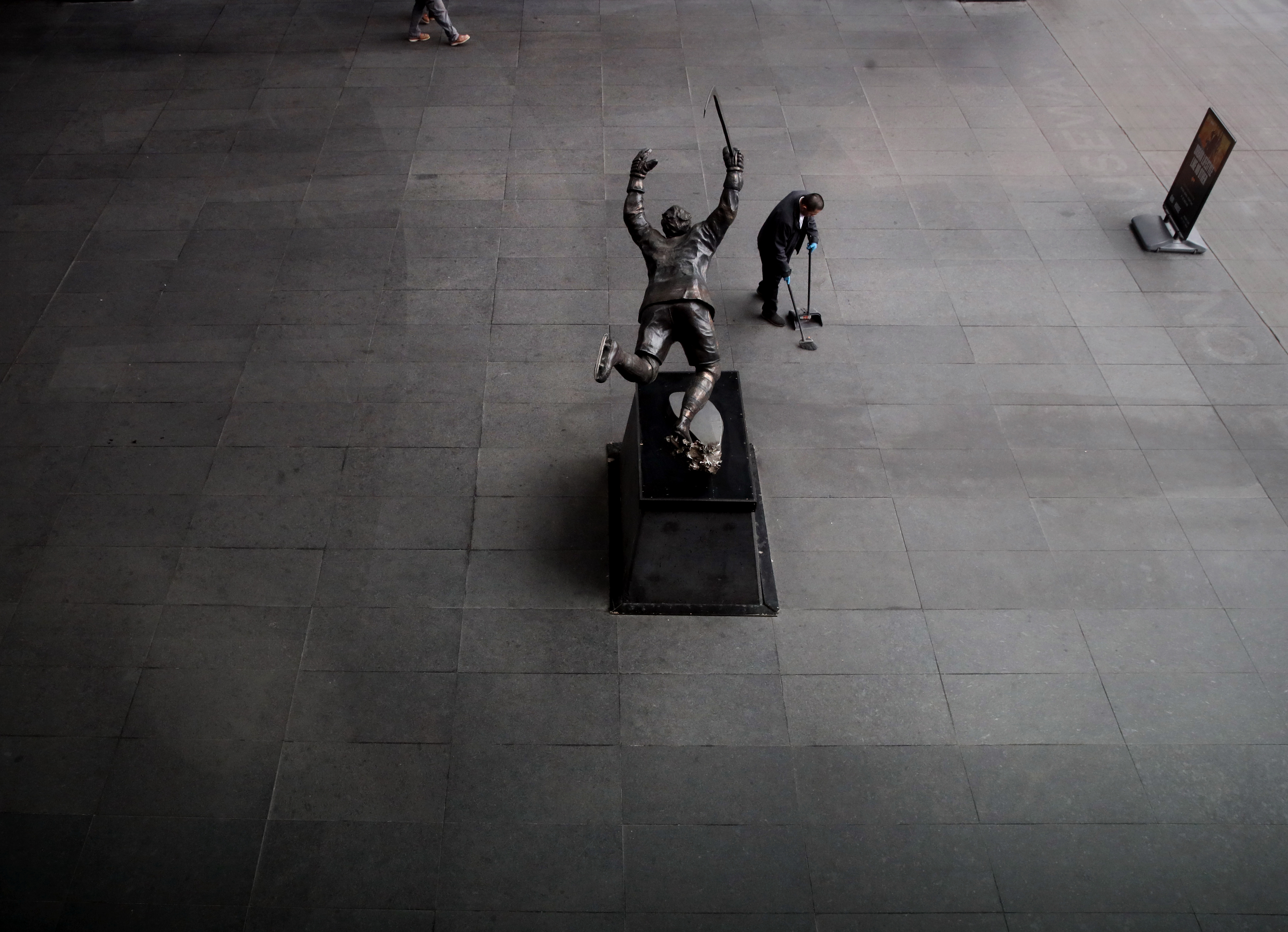 A man cleaned near the Bobby Orr Statue outside the TD Garden.