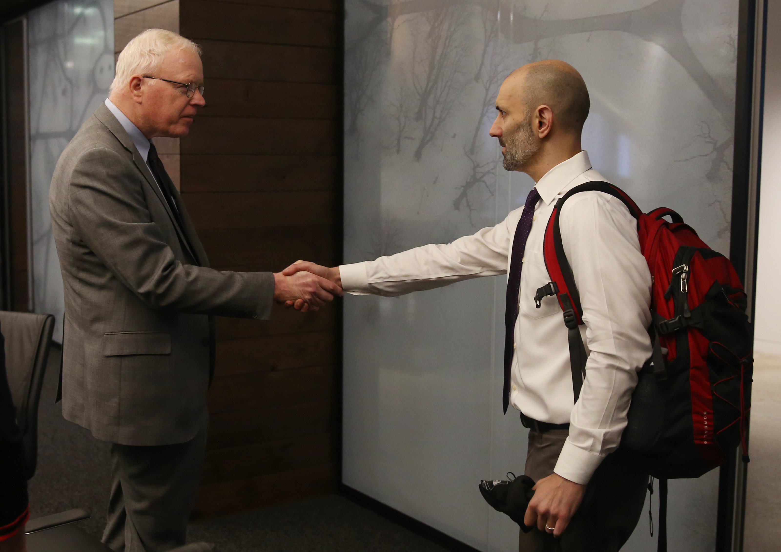Patrick Wardell, chief executive officer (left) shook hands with Pete DeMarco at the start of a meeting.