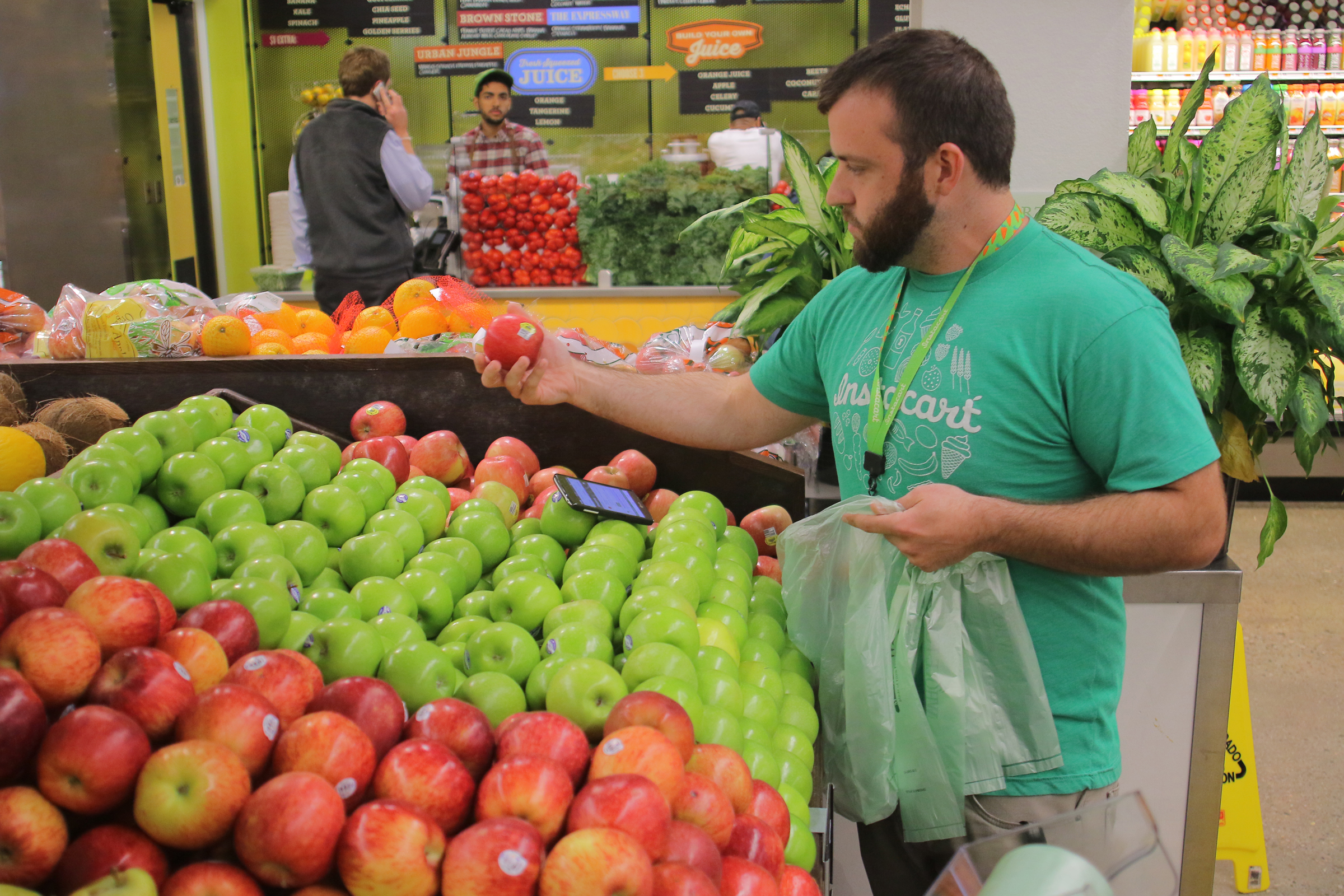 An Instacart shift captain shops for a customer in the South End Whole Foods Market.