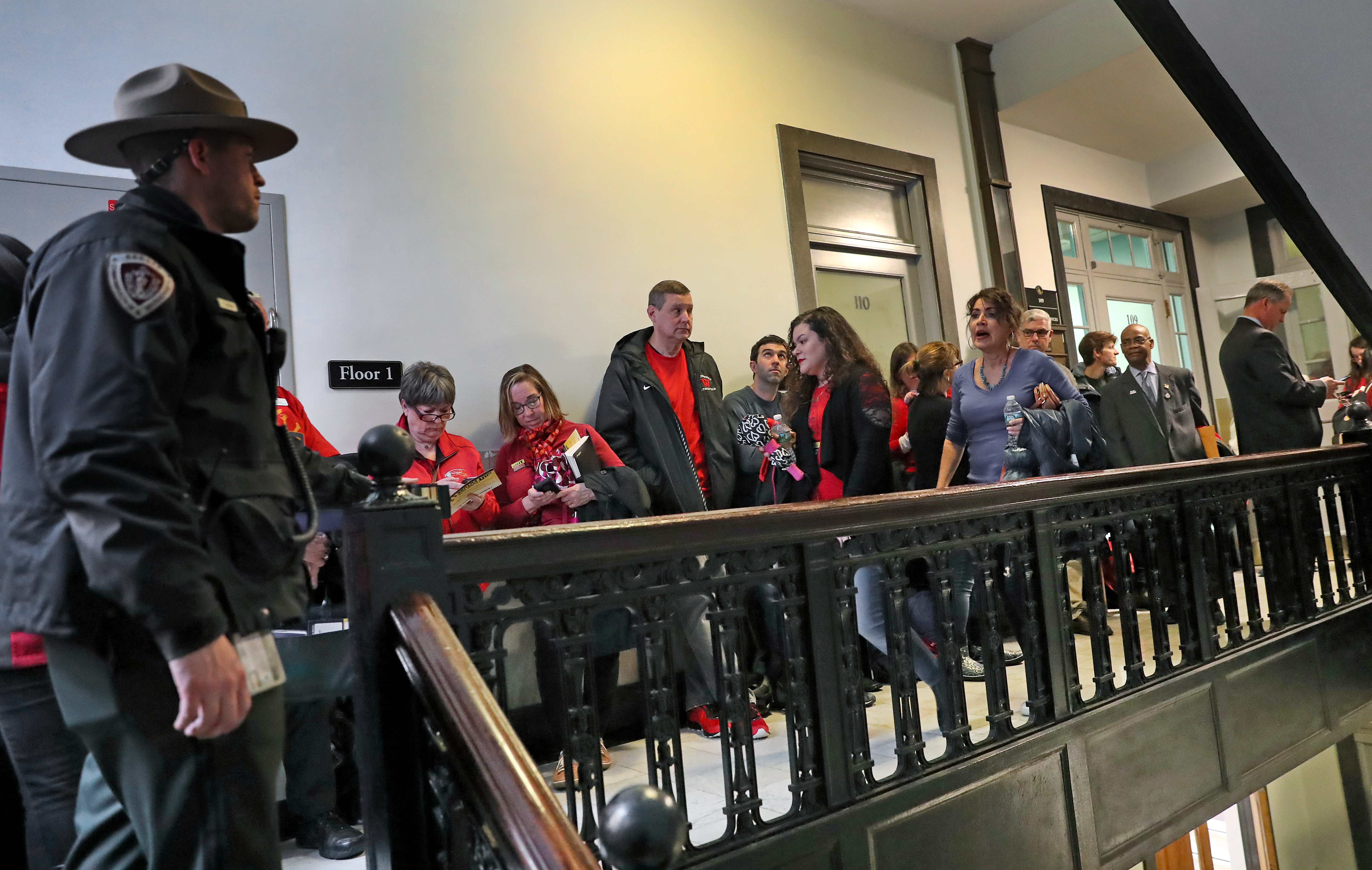 People waited in line outside the Gardner Auditorium at the State House during a major hearing on education funding measures.