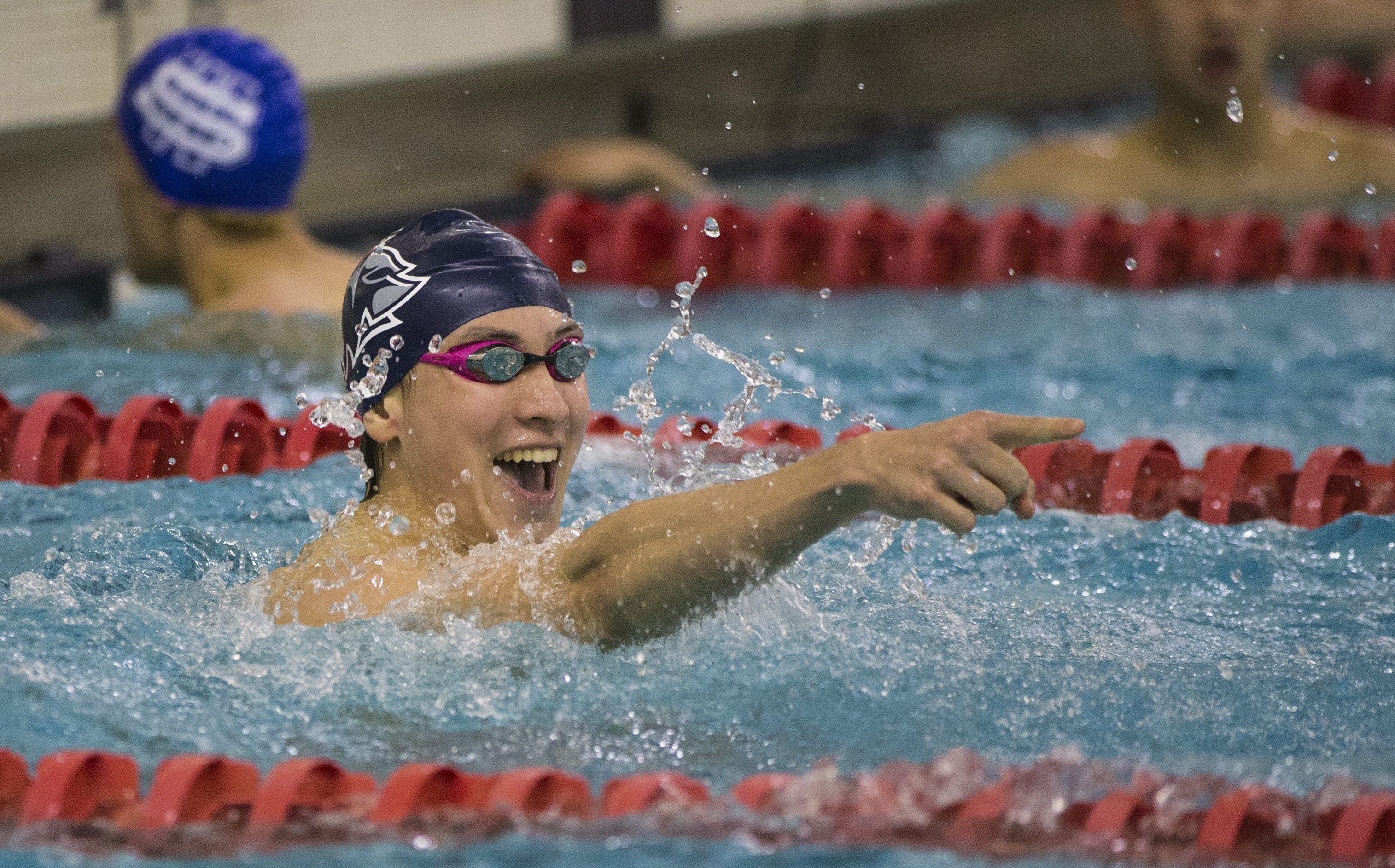 Brookline's Soeren Euvrard points the way for his team after winning the 100 freestyle.