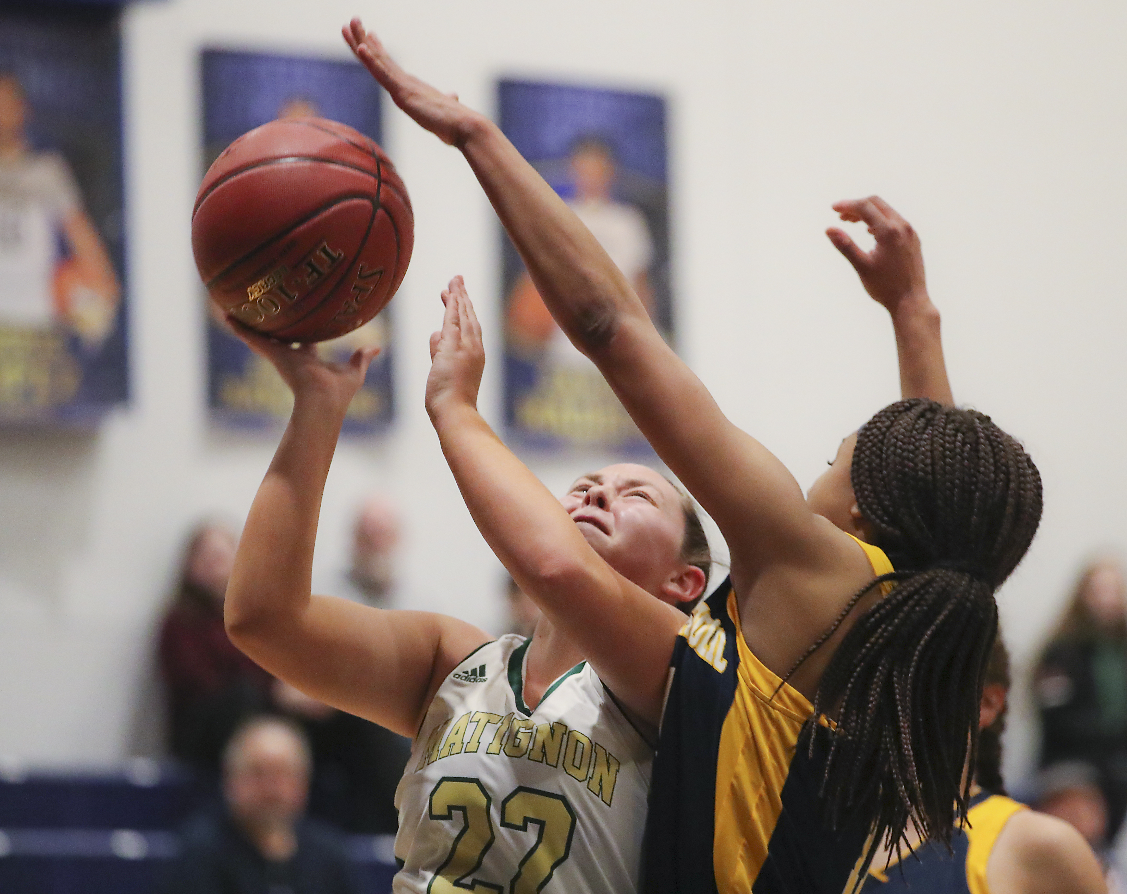 Matignon’s Meghan Lynch is fouled by Malden Catholic’s Andrea Turner enroute to a 3-point play.