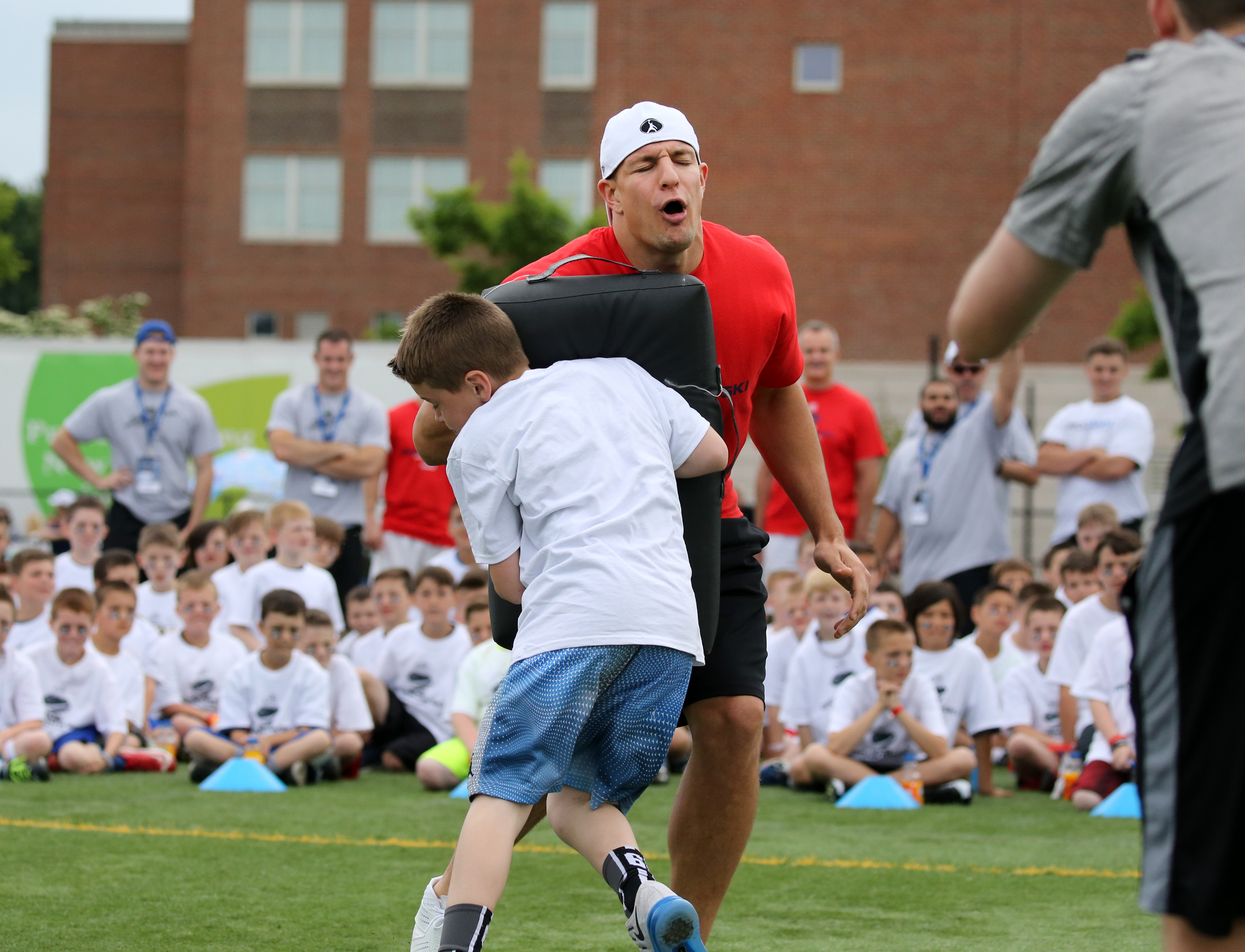 Patriots tight end Rob Gronkowski absorbed a hard hit during his football clinic at Woburn High School.