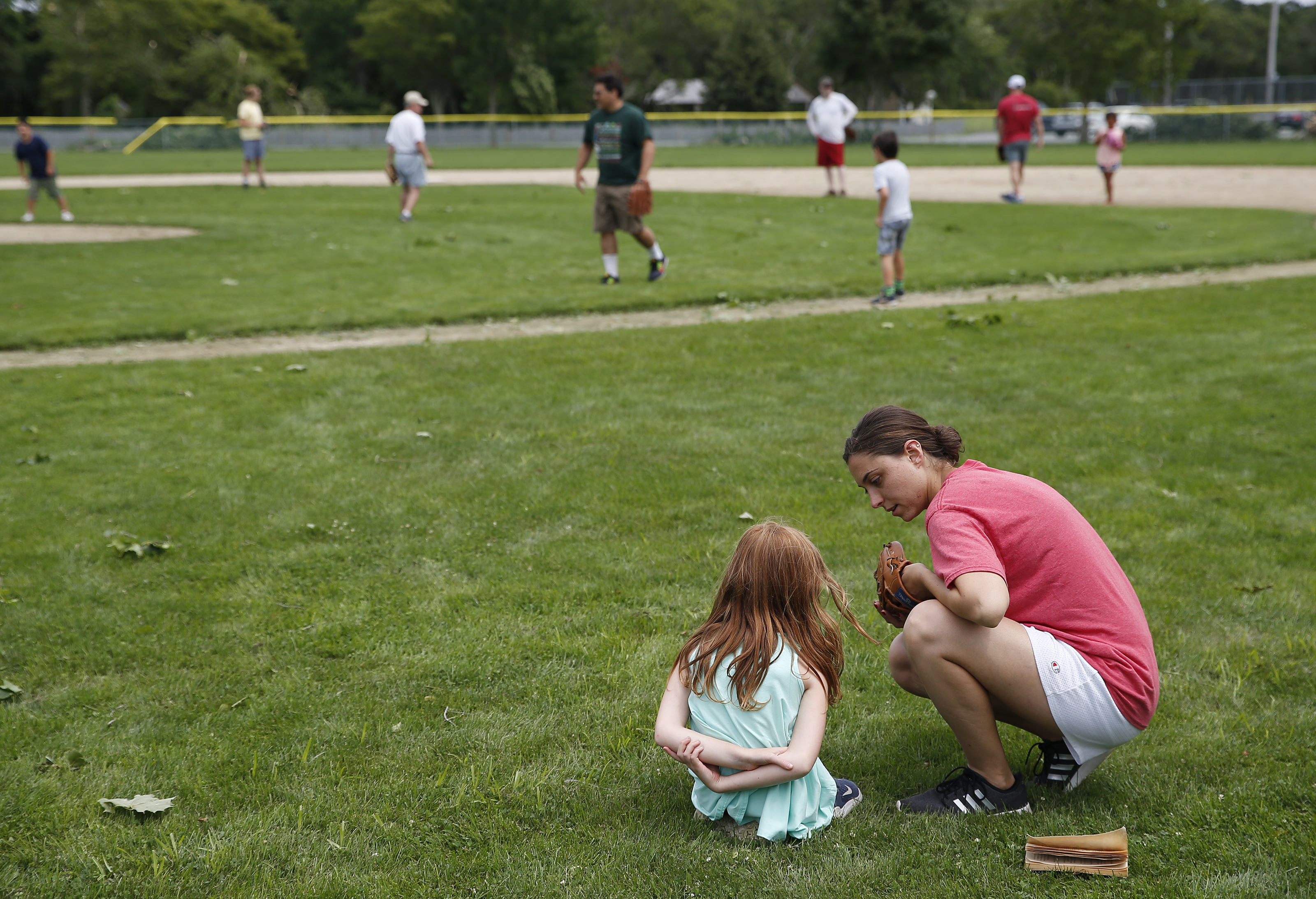 Andrea Rizzo and her daughter Millie watched while an impromptu softball game happened in Harwich.