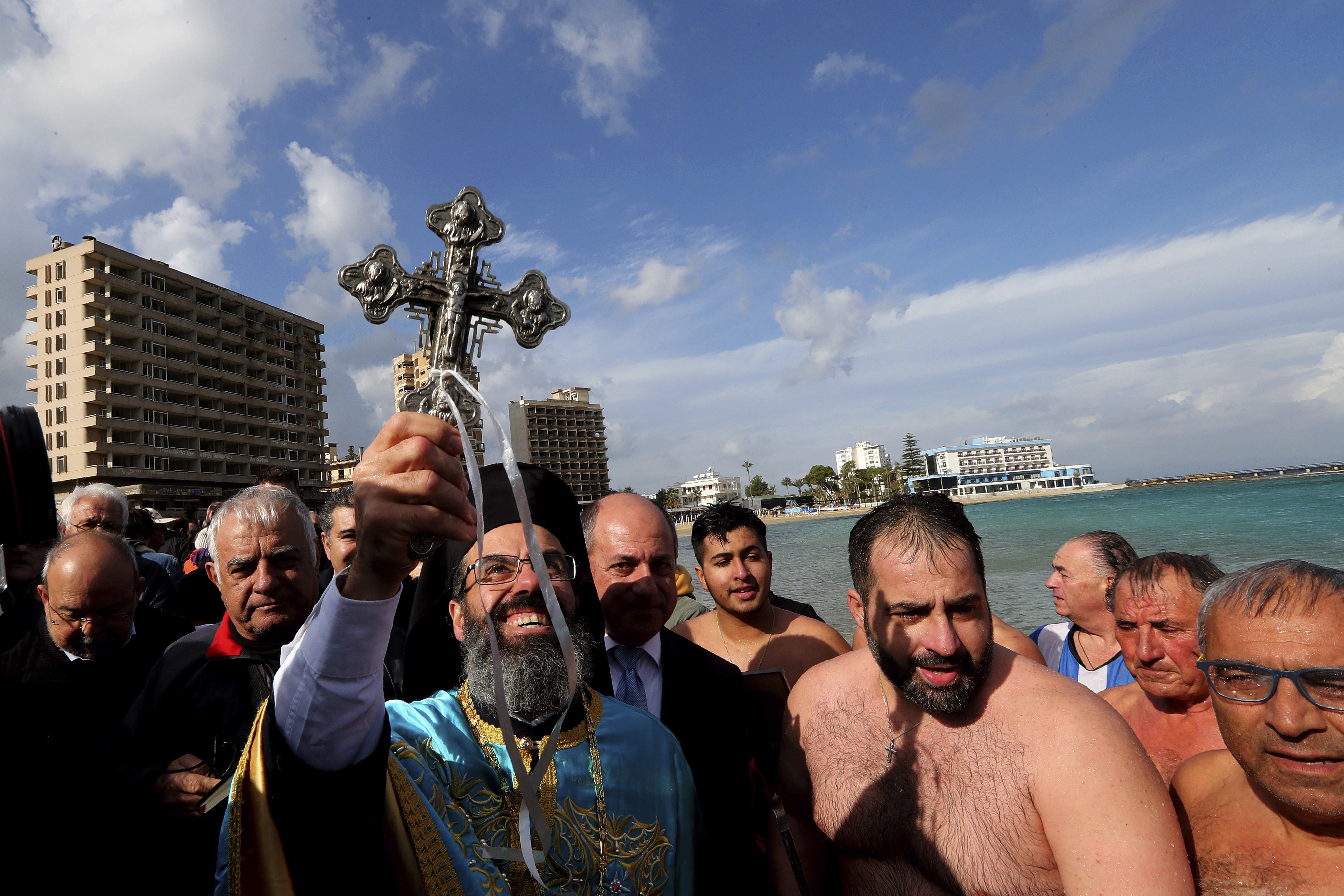 A Christian Orthodox priest held up a retrieved cross during an Epiphany ceremony on Cyprus.