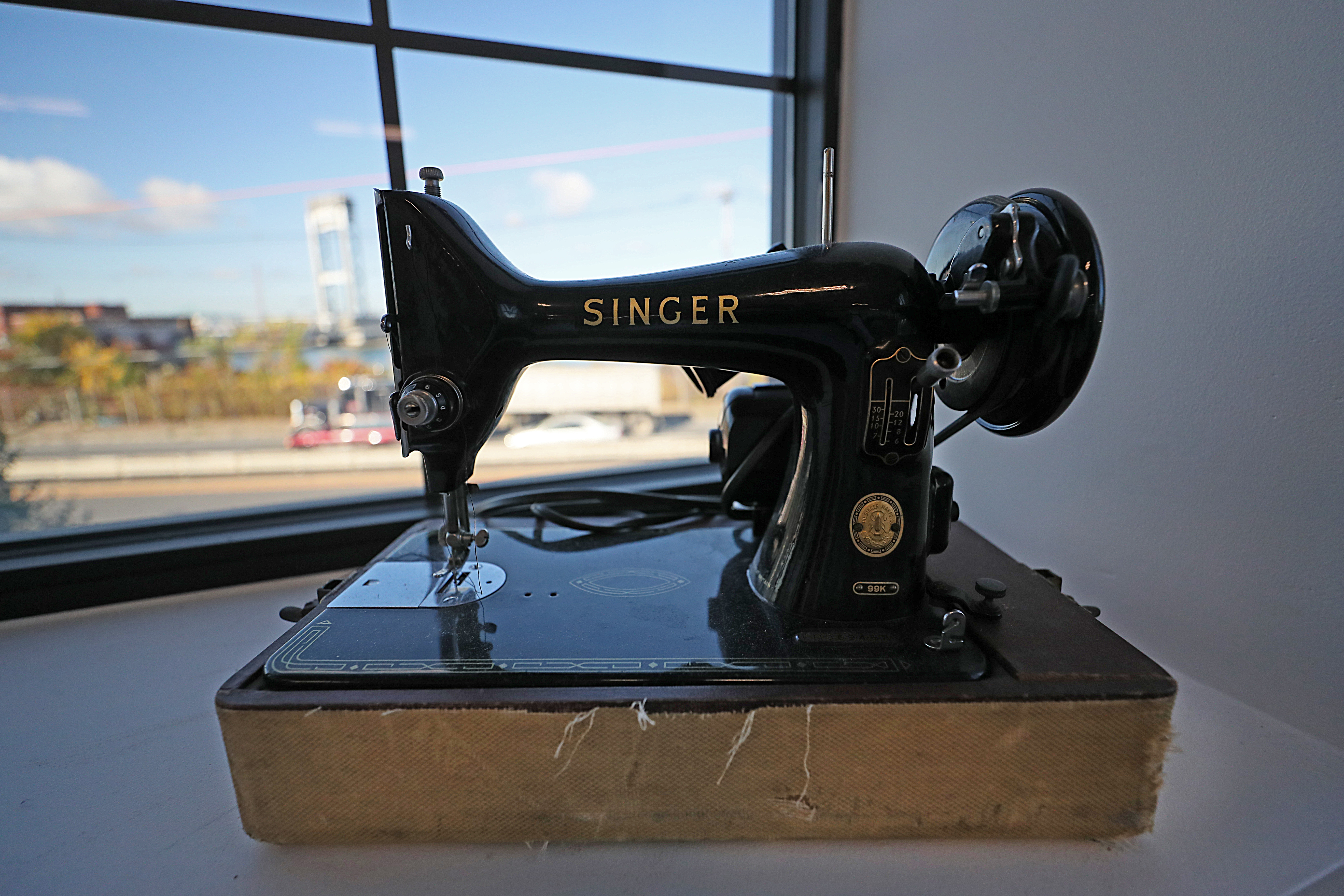 An old sewing machine with views of the Chelsea Street Bridge at ThreadTech in East Boston.