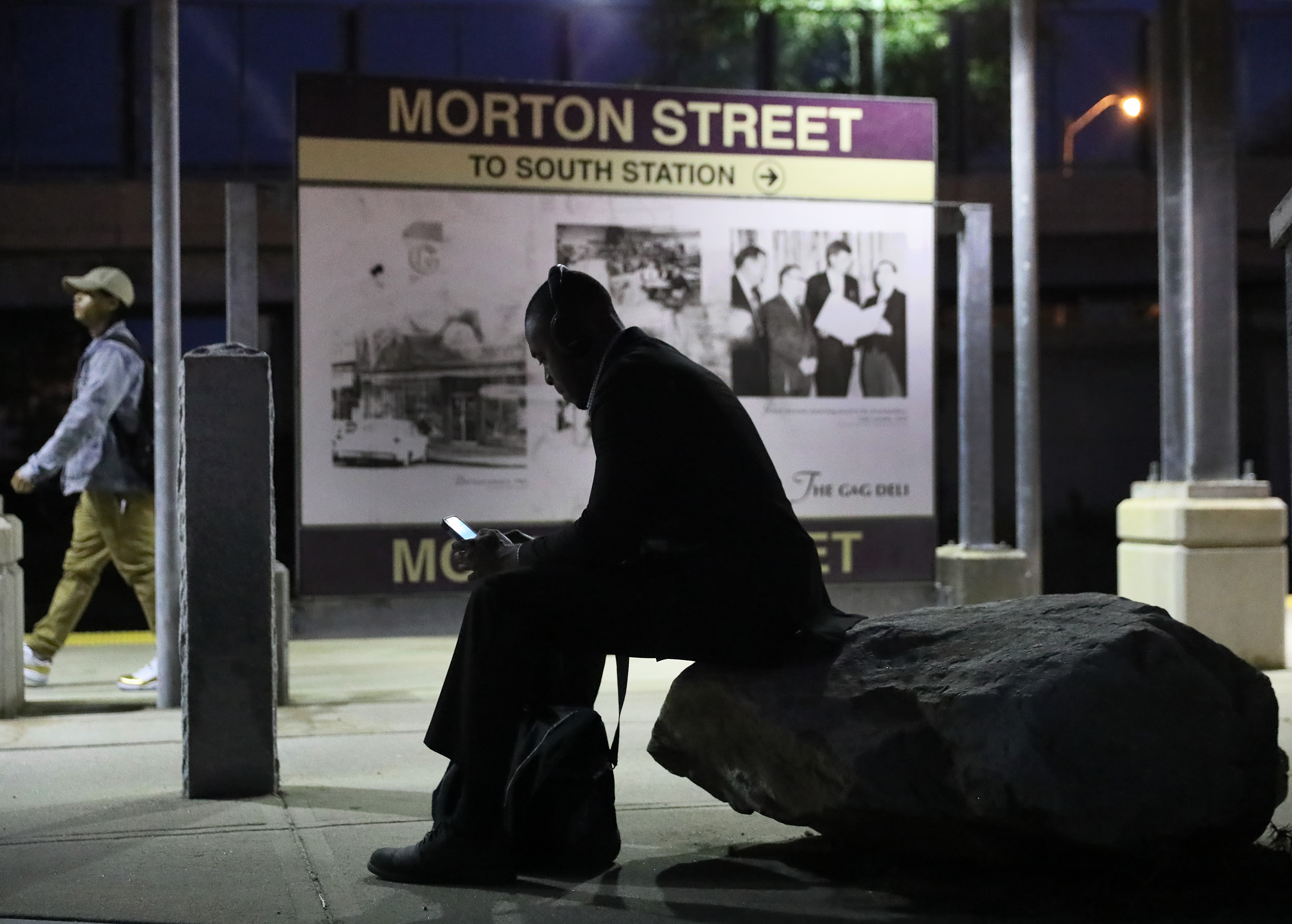 Stanley Innocent sat on a rock waiting for a train at Morton Street.