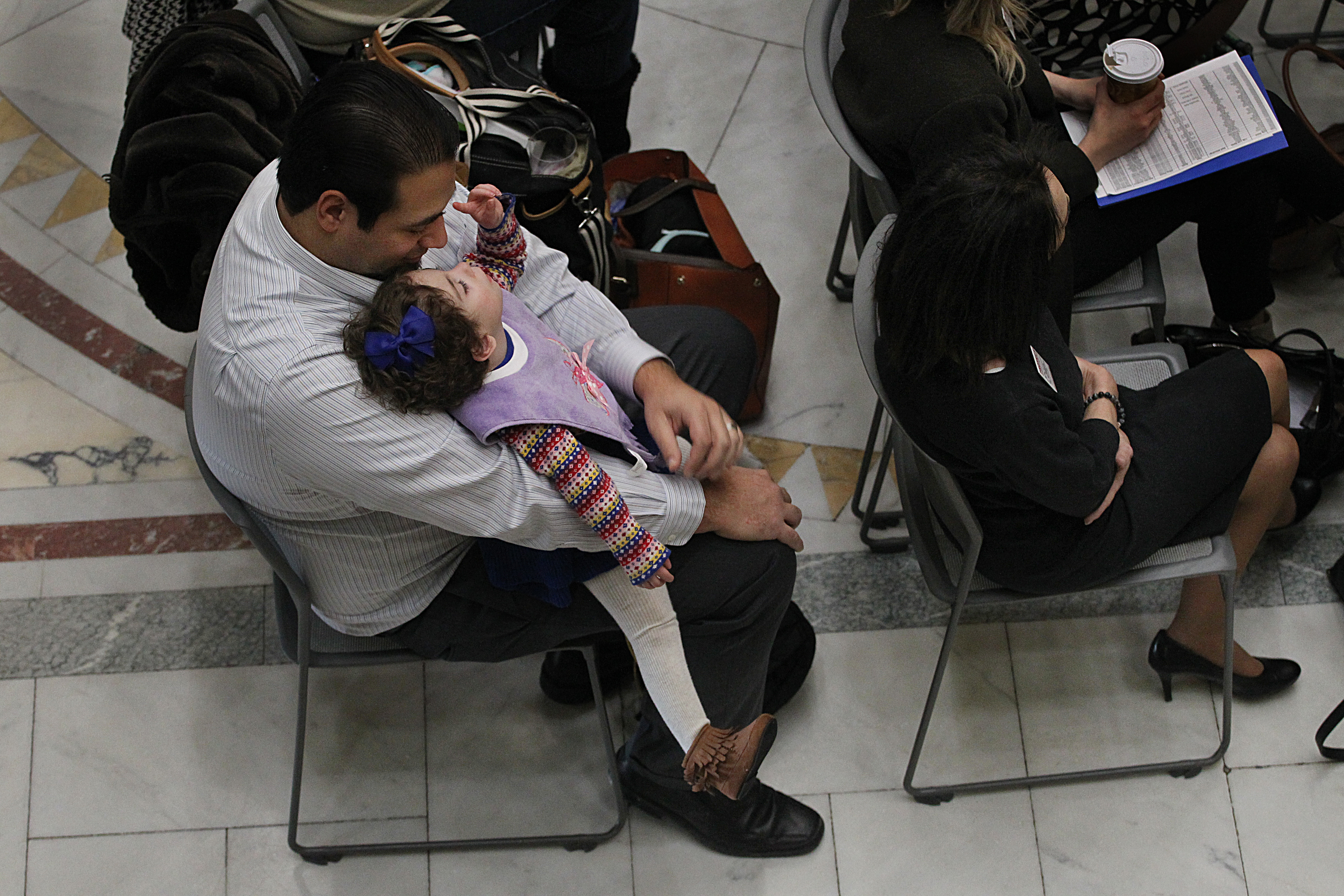 Manny Ortiz and daughter Ayla went to the State House to show support for a bill to help expand in-home nursing.