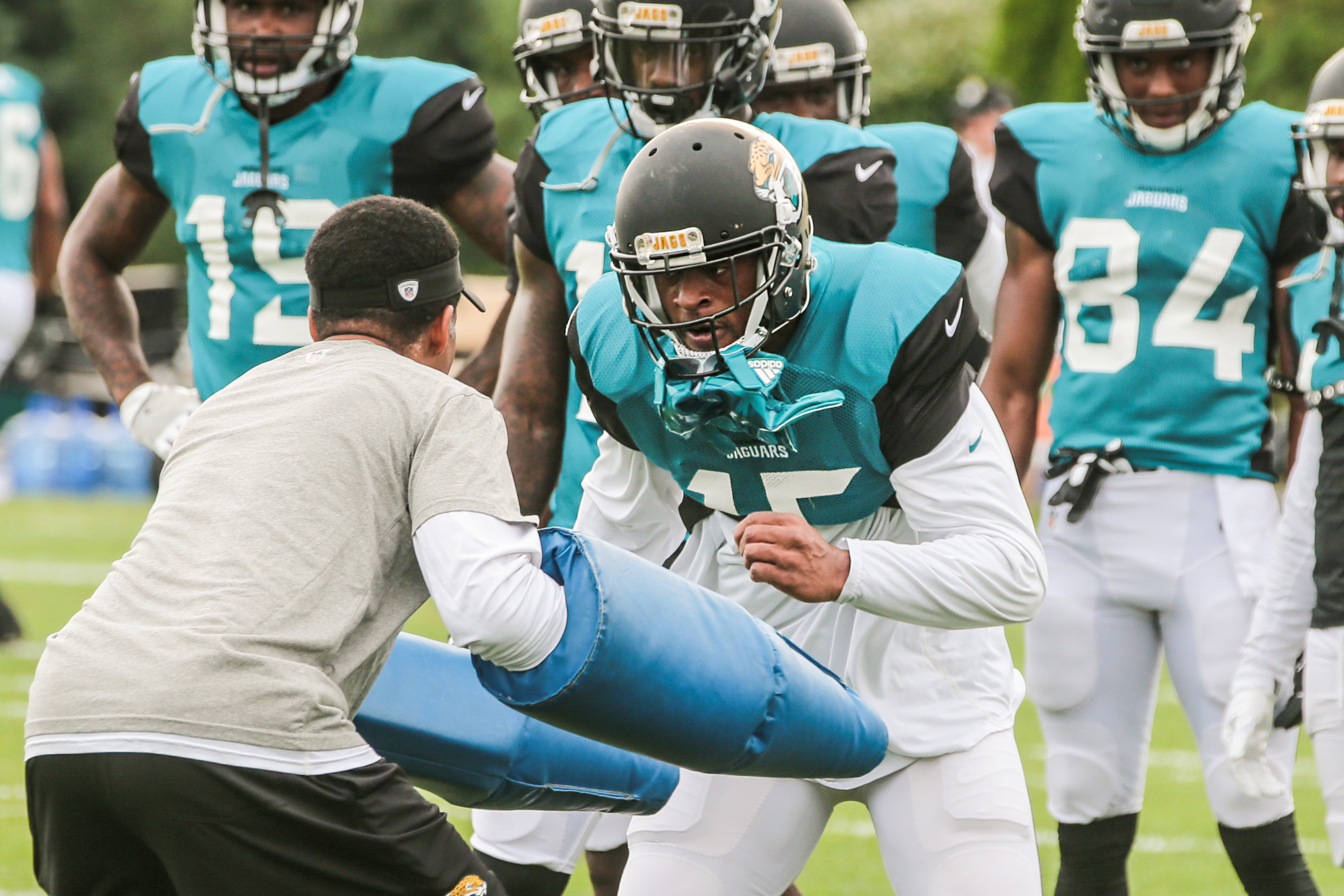 The Jaguars’ Allen Robinson runs into a coach’s block at a joint practice with the Patriots.
