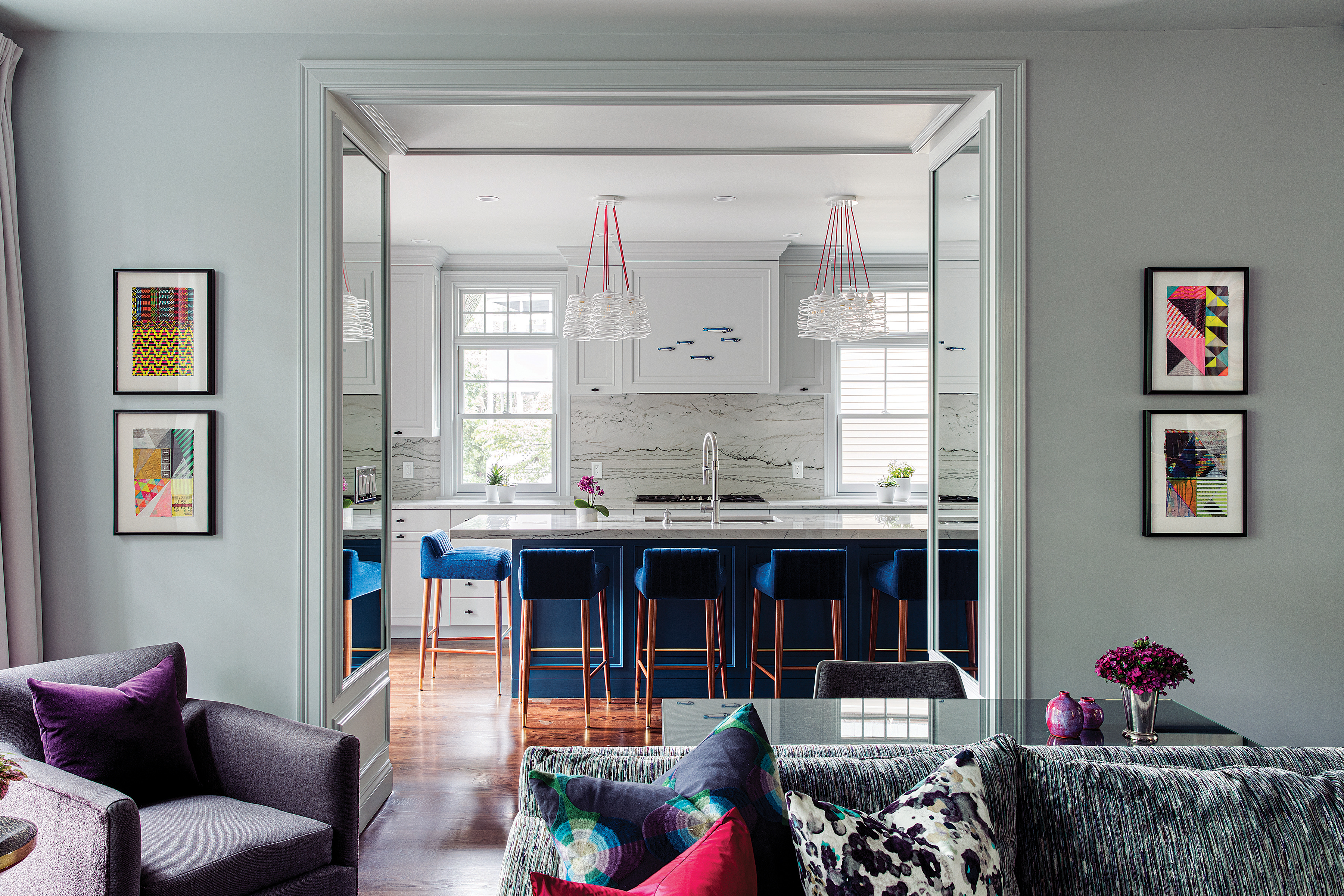 The kitchen counter stools by Munna are upholstered in navy mohair velvet by Pierre Frey.