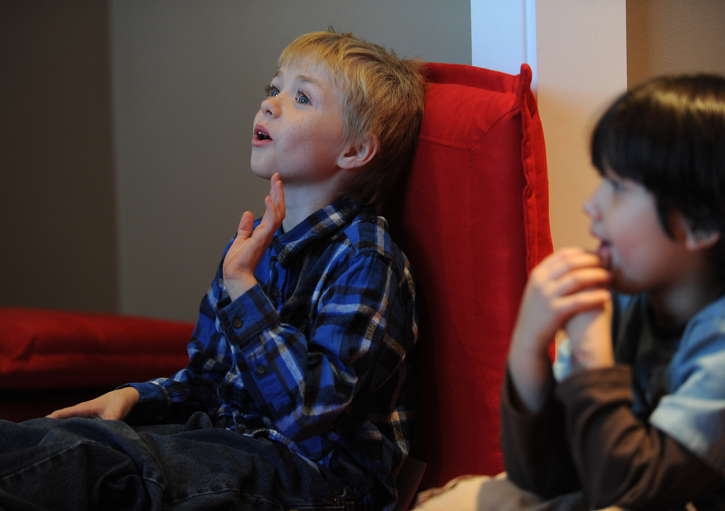 Eight-year-old Bjorn Olsson signals that he is ready to answer a question.
