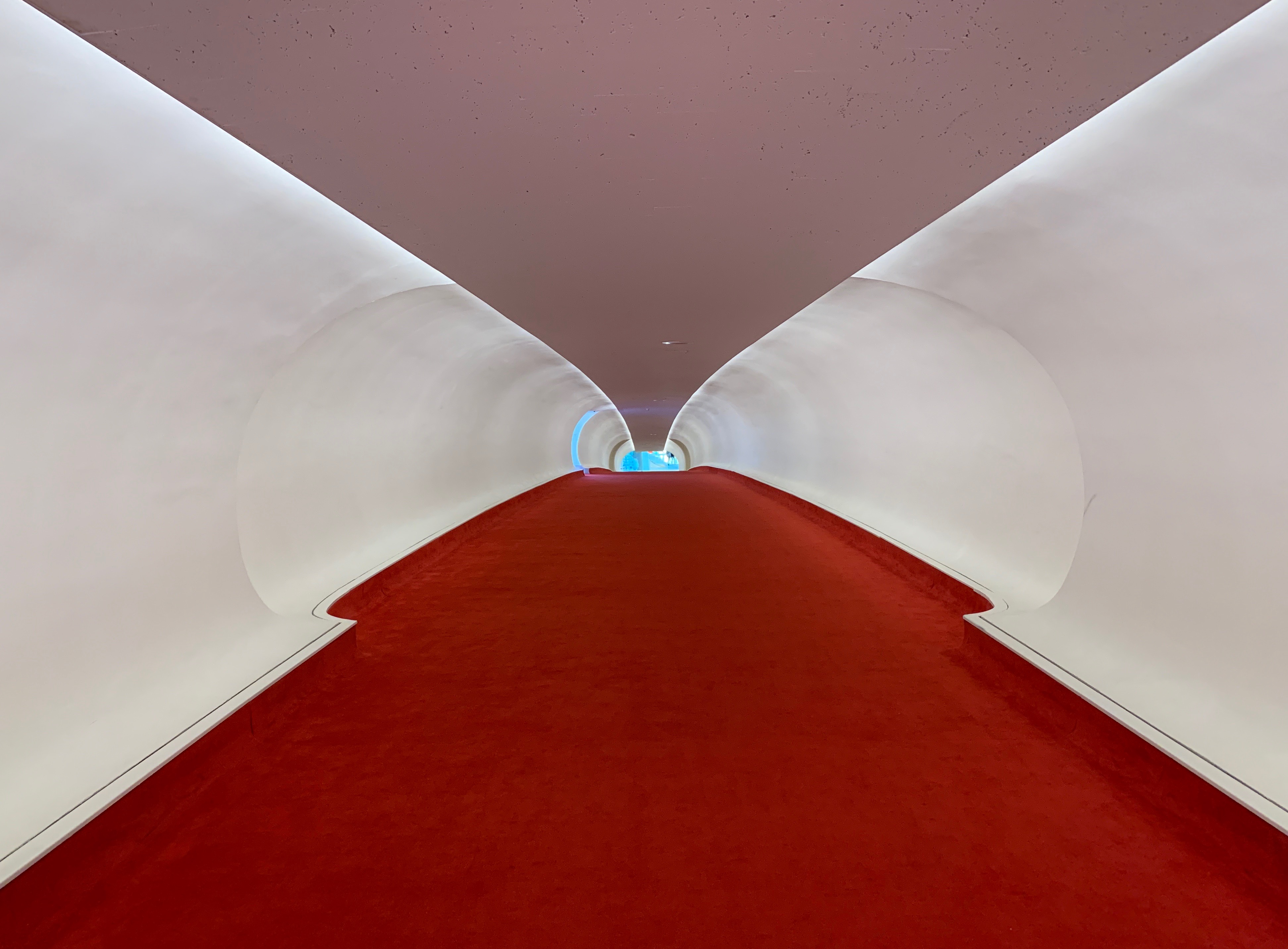 One of the dramatic hallways, designed by Eero Saarinen, at the TWA Hotel at JFK Airport.