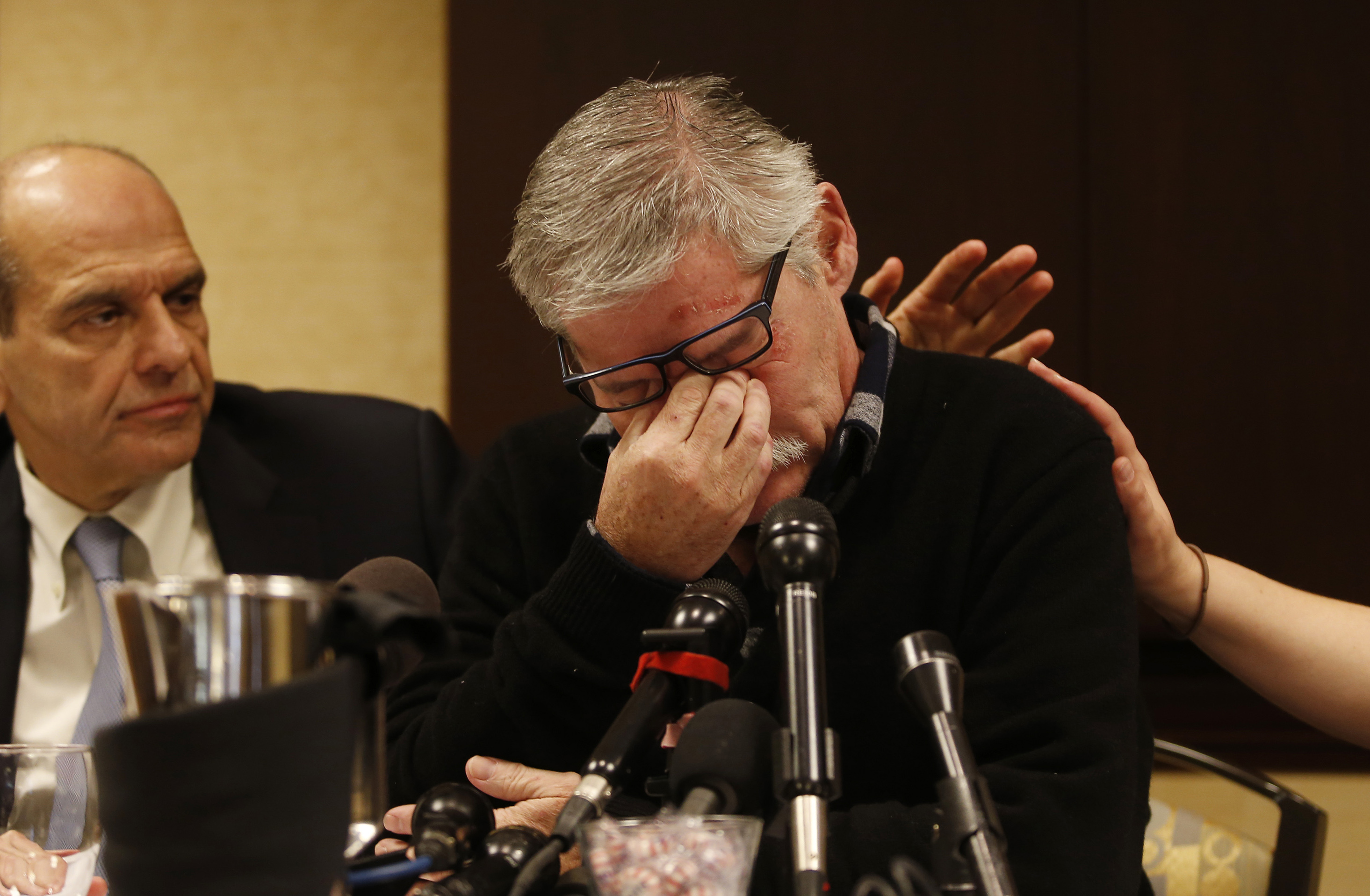 Attorney Mitchell Garabedian (left) reached out to place his arm on clergy sexual abuse survivor Robert Costello as he broke down during a press conference on Wednesday.