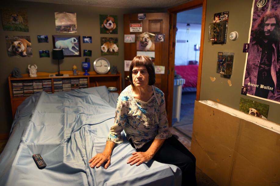 Carmela Correia, 73, in the basement bedroom used by her son, Paul. The schizophrenia patient was 45 when he died after being strapped to a bed at Bridgewater State Hospital.