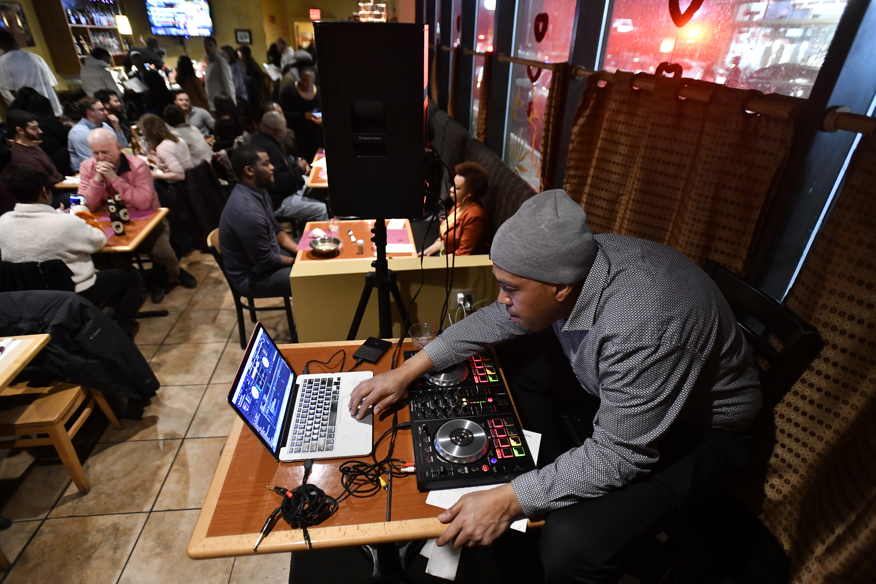 Justin Springer, of Outside the Box, DJed at Suya Joint in Dudley Square, during the first event in Boston Black Restaurant Challenge.