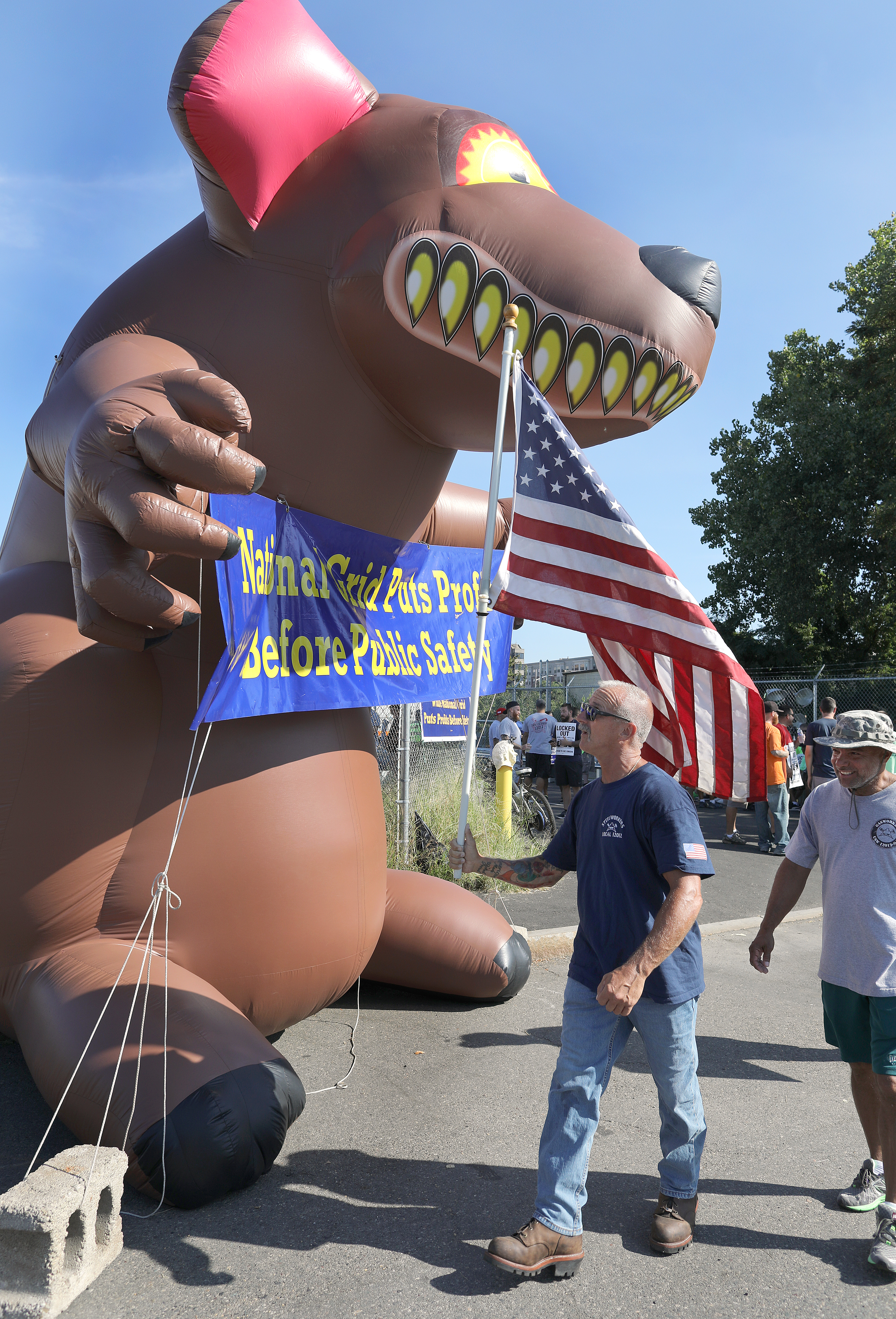 Union members are using old-school hardball tactics, including an inflatable rat, to pressure National Grid.