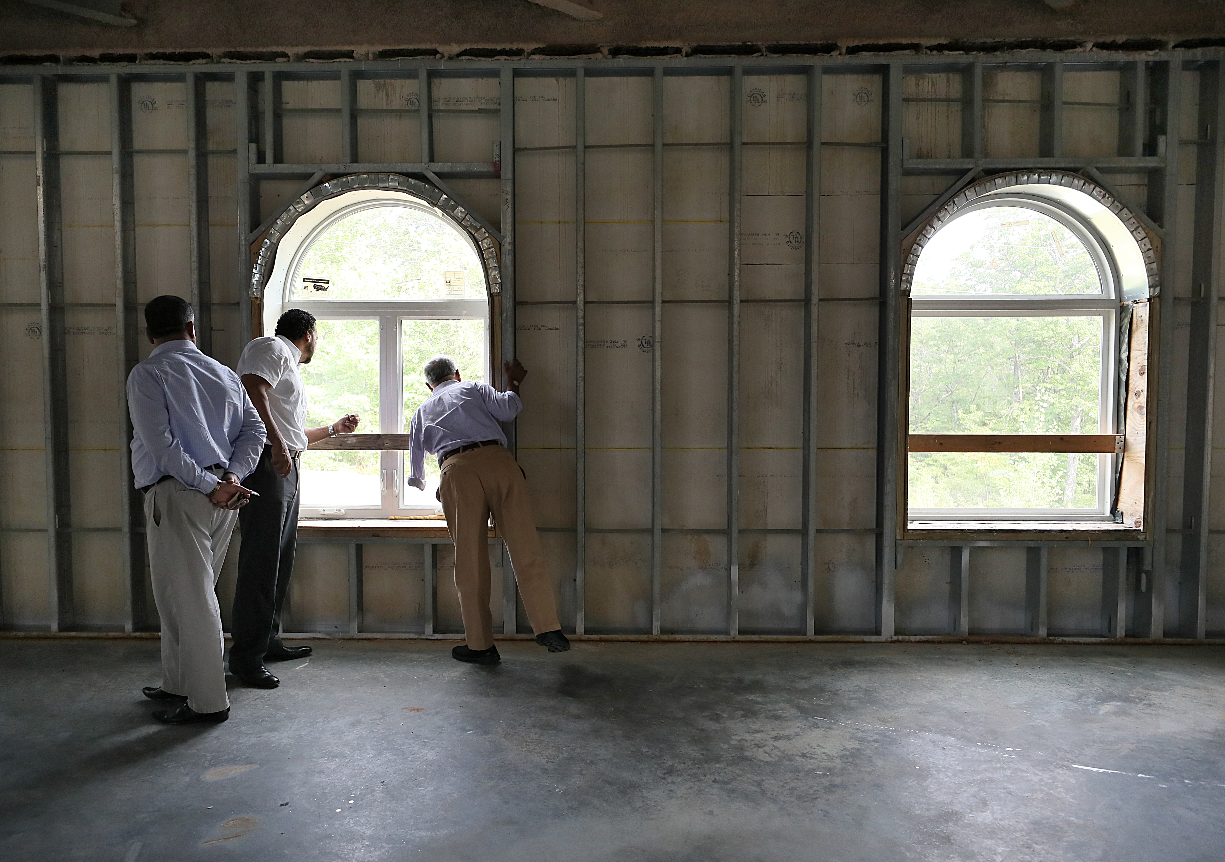 From left: Habid Ullah, Islamic Society of New Hampshire member; Mohammed Ewiess, mosque board president; and Mahboubul Hassan, board member, examined the mosque.