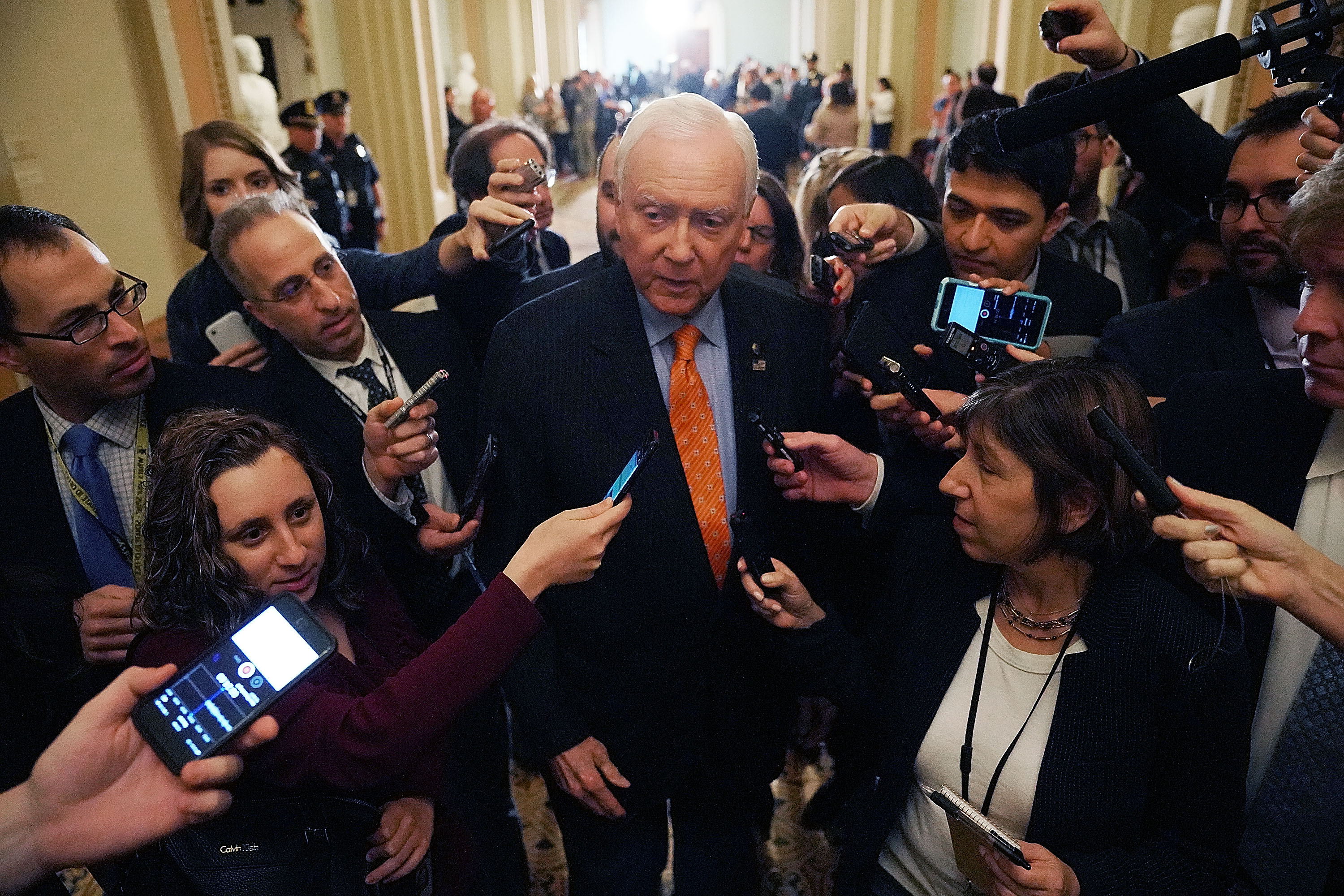 On Nov. 14, Senate Finance Committee Chairman Orrin Hatch is surrounded by reporters as he leaves the weekly Senate Republican policy luncheon. Senate Republicans are considering including a repeal of the Obamacare individual mandate as part of their proposed tax cut and reform legislation.