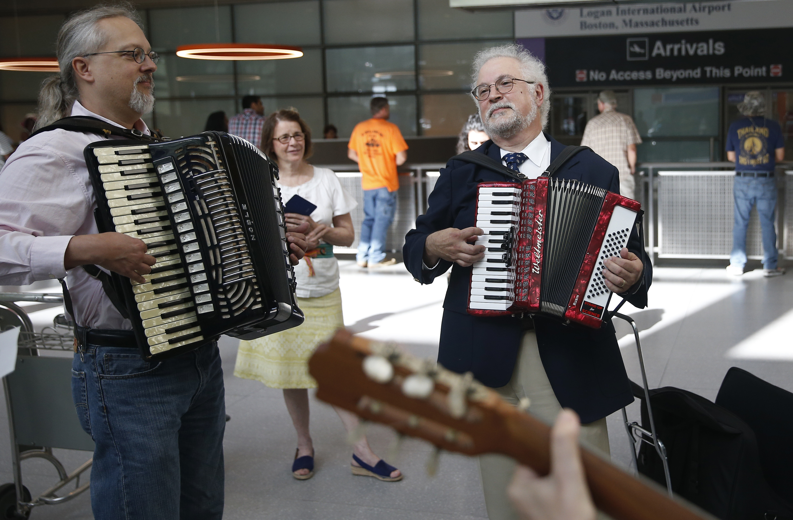 Colin Ferguson of Watertown and Dr. Thomas Michel played in Terminal E as they waited for Saravi to arrive.