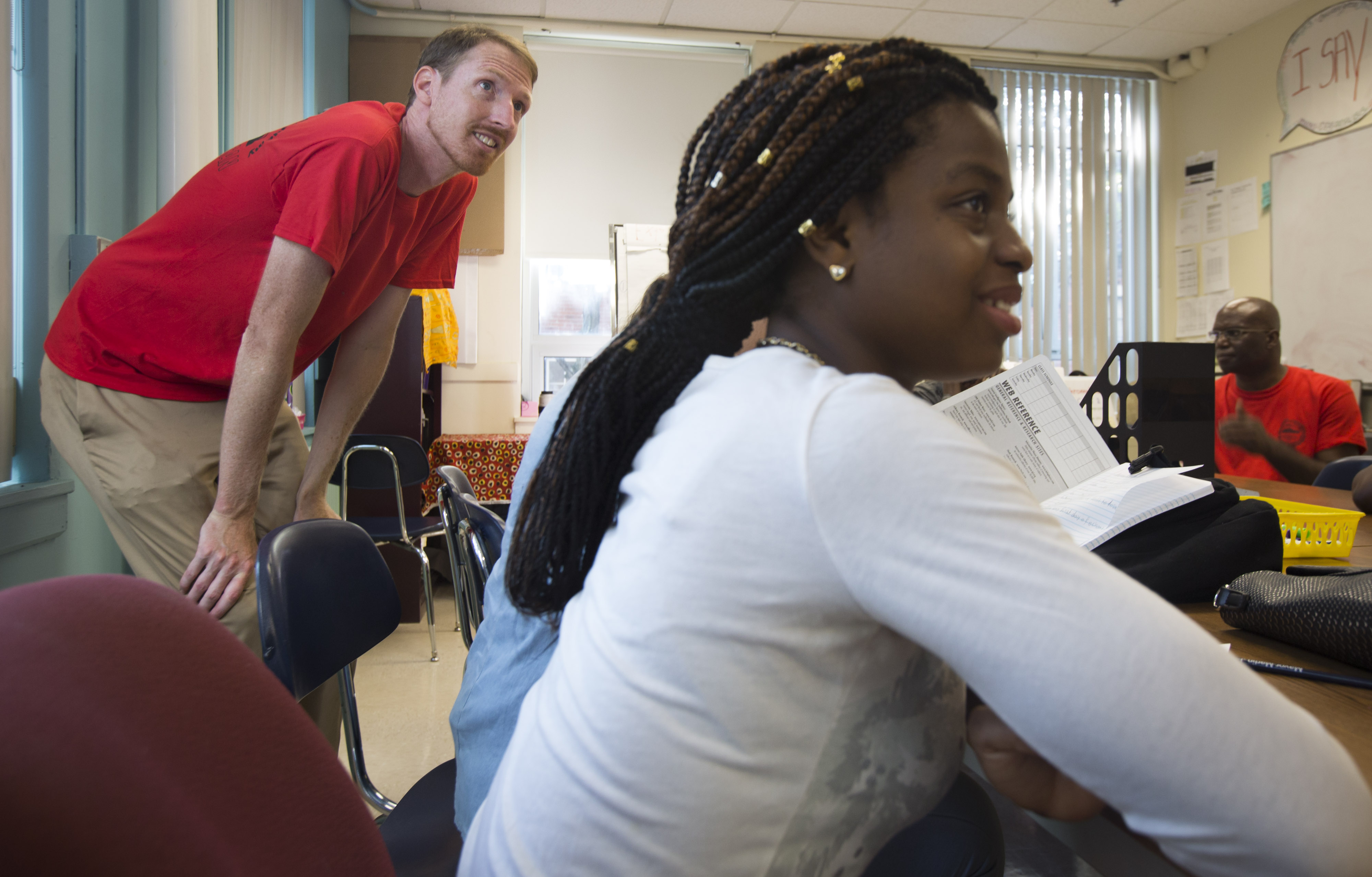 Teacher Nathan Eckstrom listened to his student Valancia Mathurin (right) speak during the first day of the new school year.
