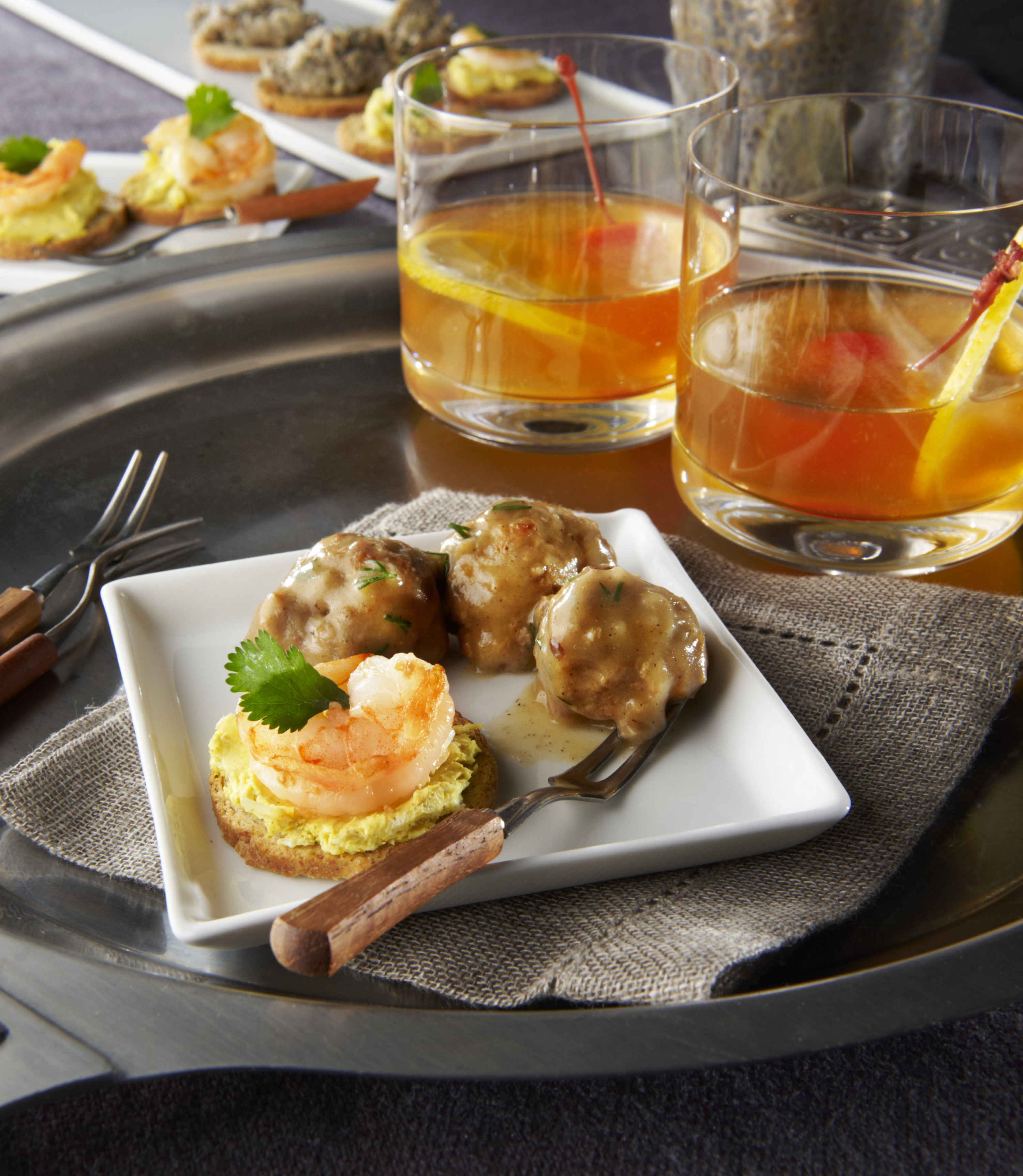 Swedish meatballs and shrimp canapes with whiskey sours.