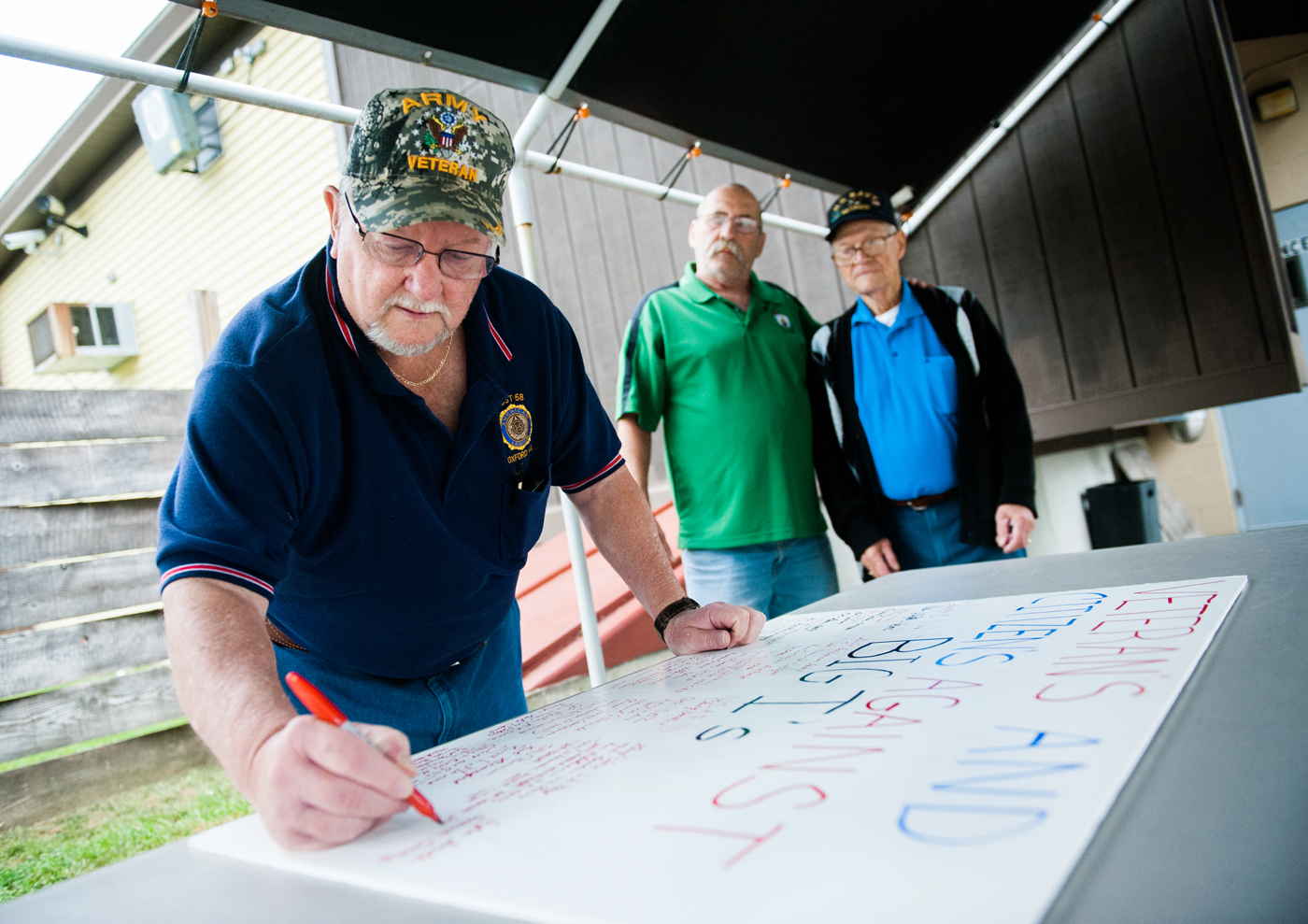 Army veteran Jim Haskell added his name to the signatures on a board that reads “Veterans and Citizens against Big I’s.”