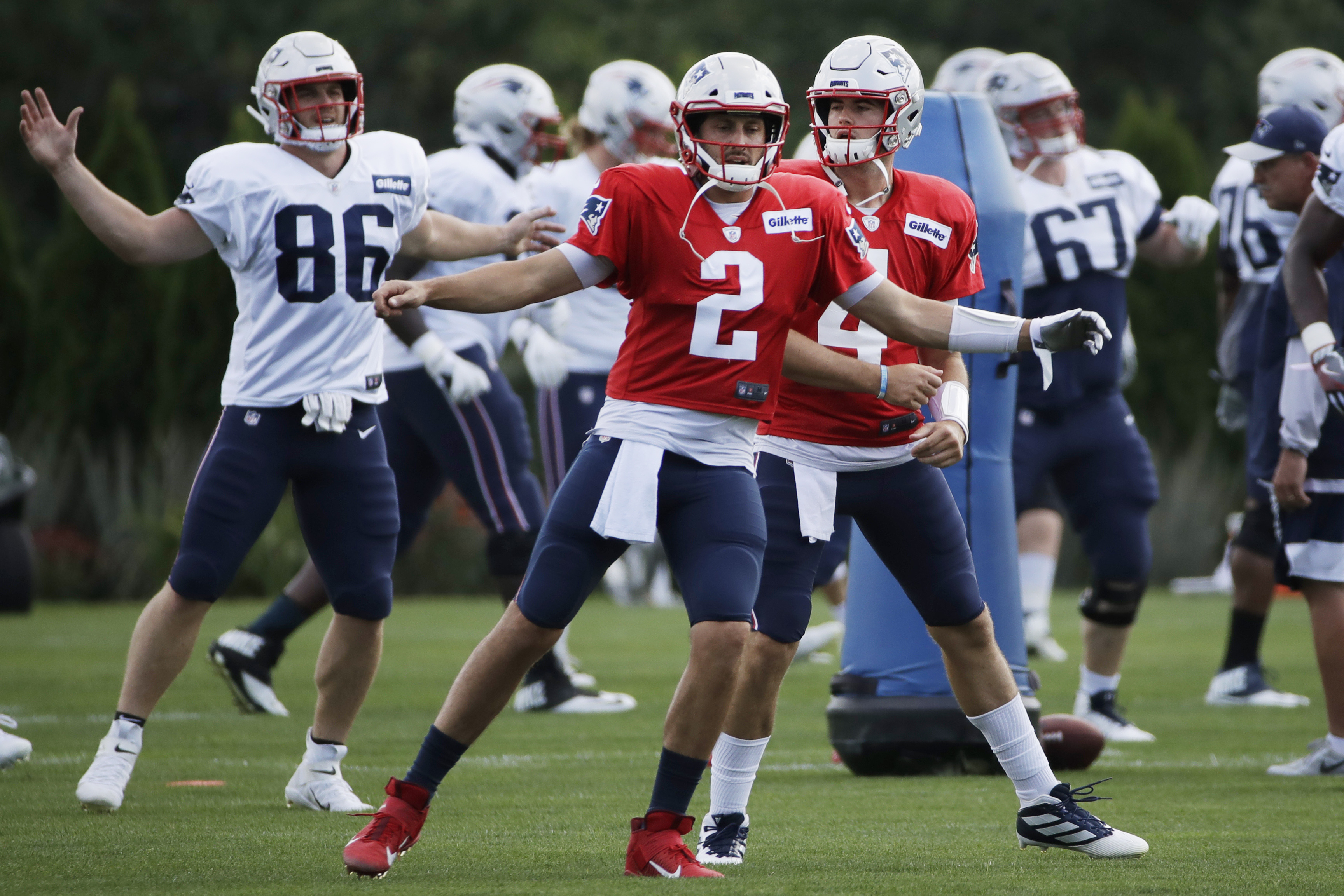 Brian Hoyer and Jarrett Stidham warm up during a 2019 training camp workout.