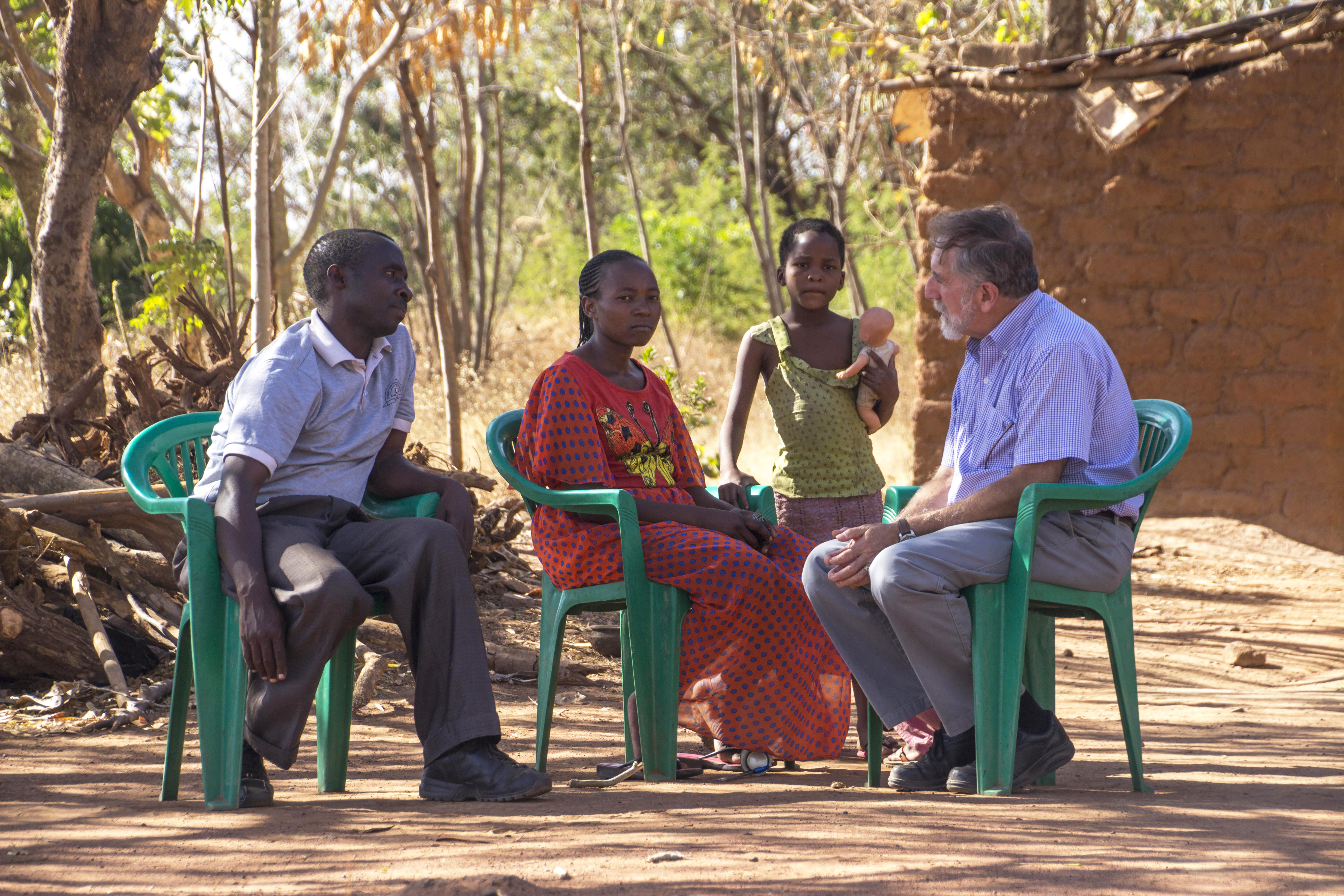 Dr. Mitchell, meeting in 2015 with a family in a rural village near Shinyanga, Tanzania.