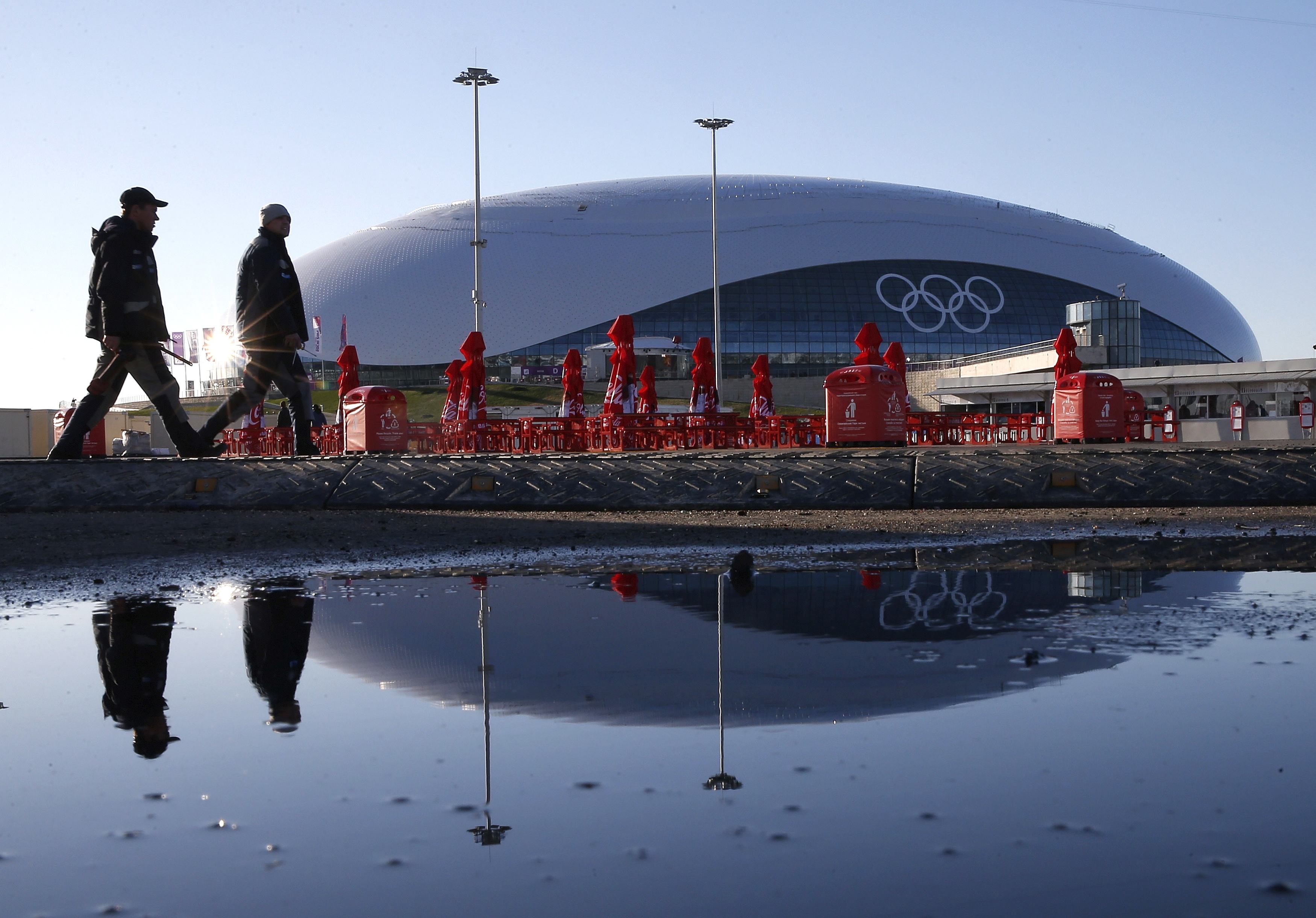 Guards walked past the Bolshoy Ice Dome at Olympic Park.