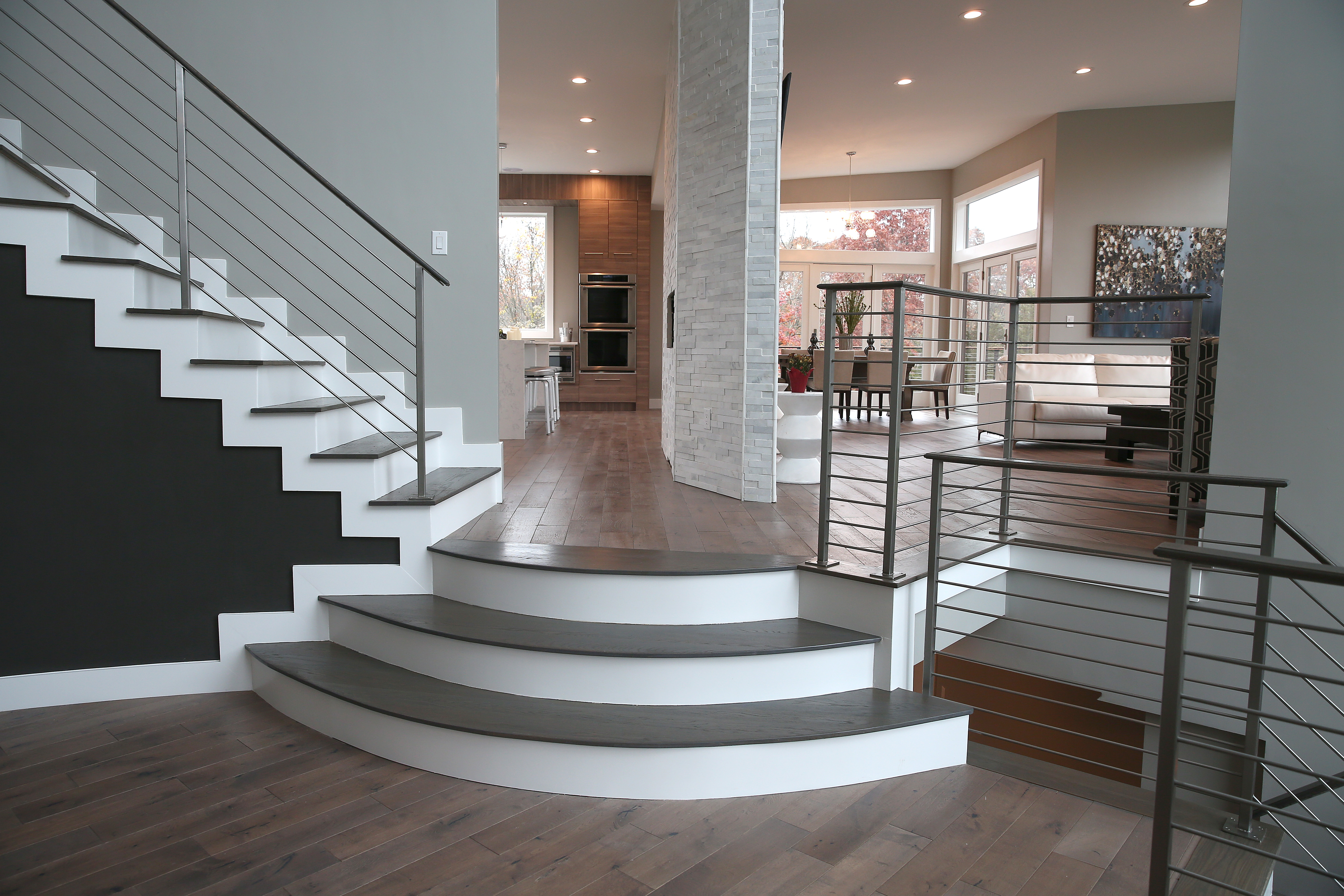 The foyer steps go to the living room, kitchen, and to the stairs that lead to the master.