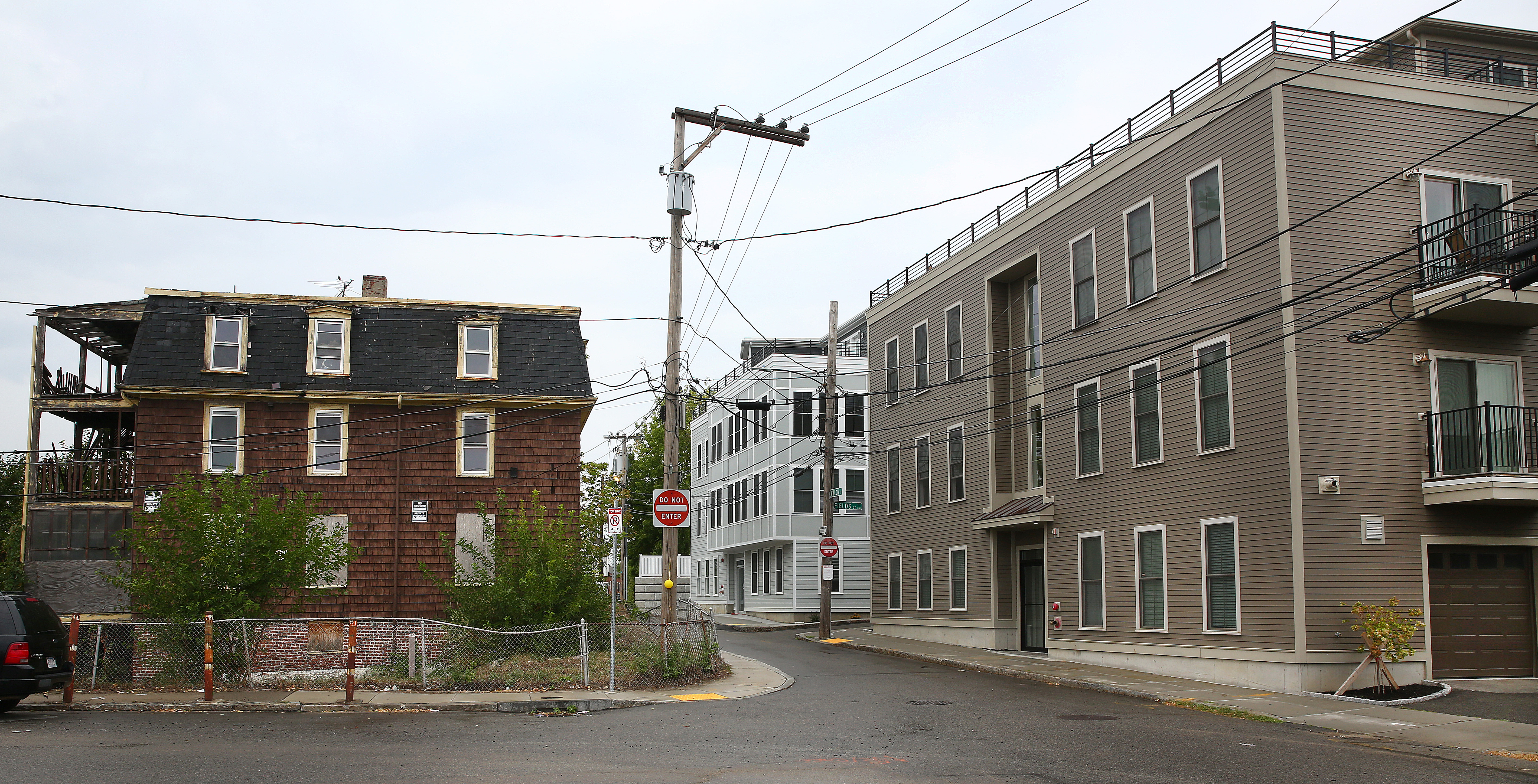 New apartment buildings at Willow Court, right, across the street from a home that was sold for $1.175 million to a developer.