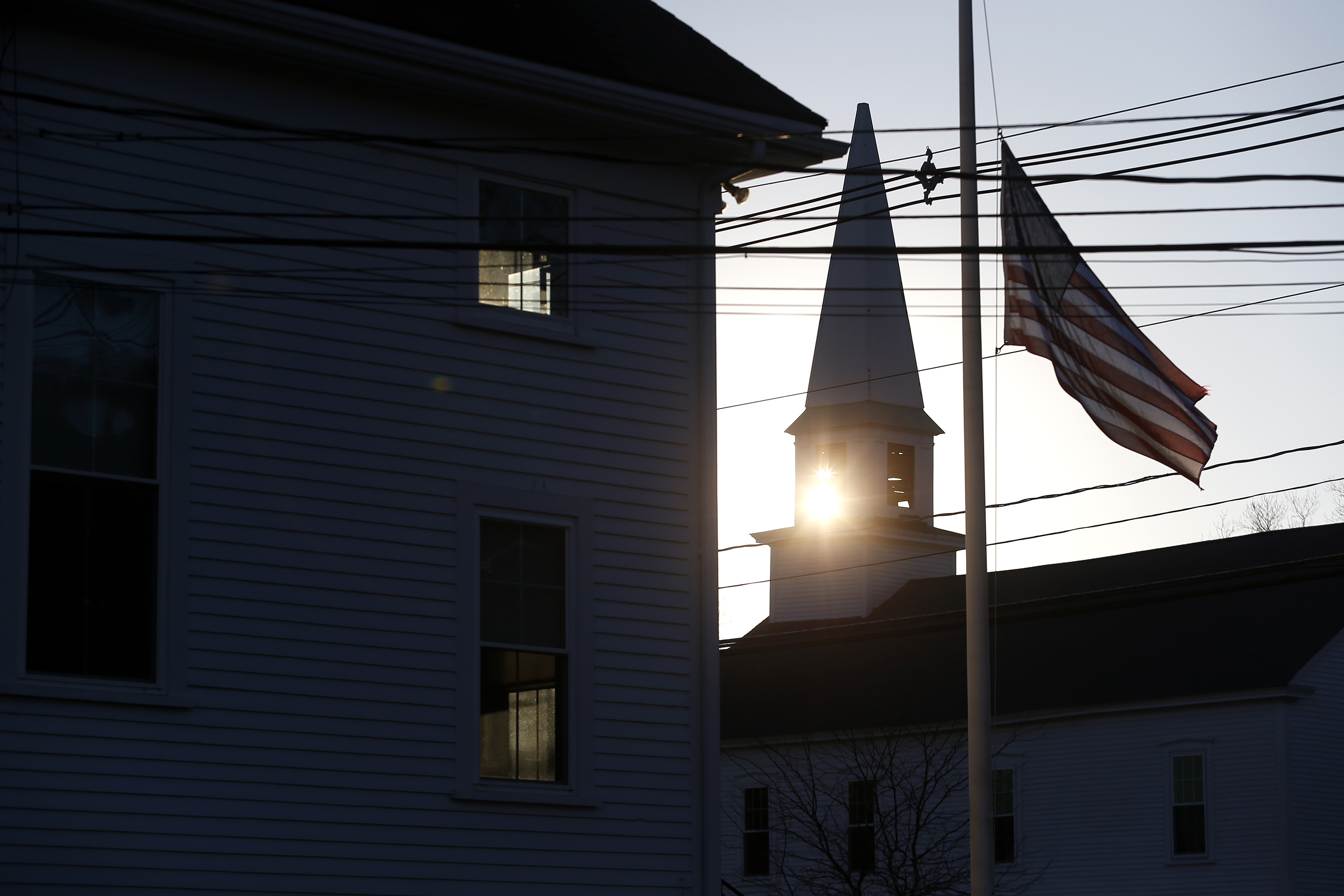 The sun set behind the steeple of United Church of Christ, Congregational in Boxborough.
