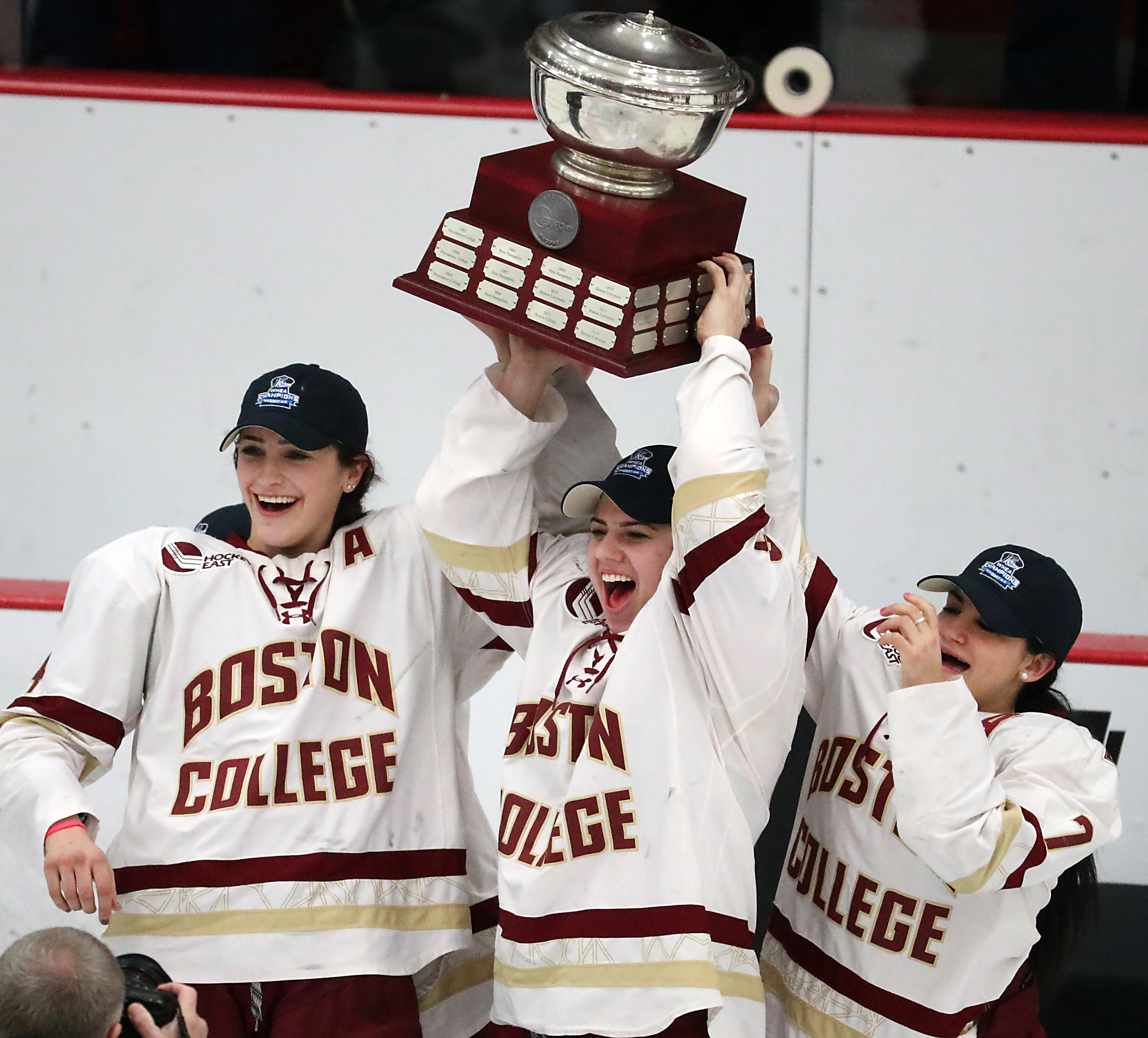 From left: Megan Keller, Anastos, and Kristyn Capizzano held up the Hockey East trophy.