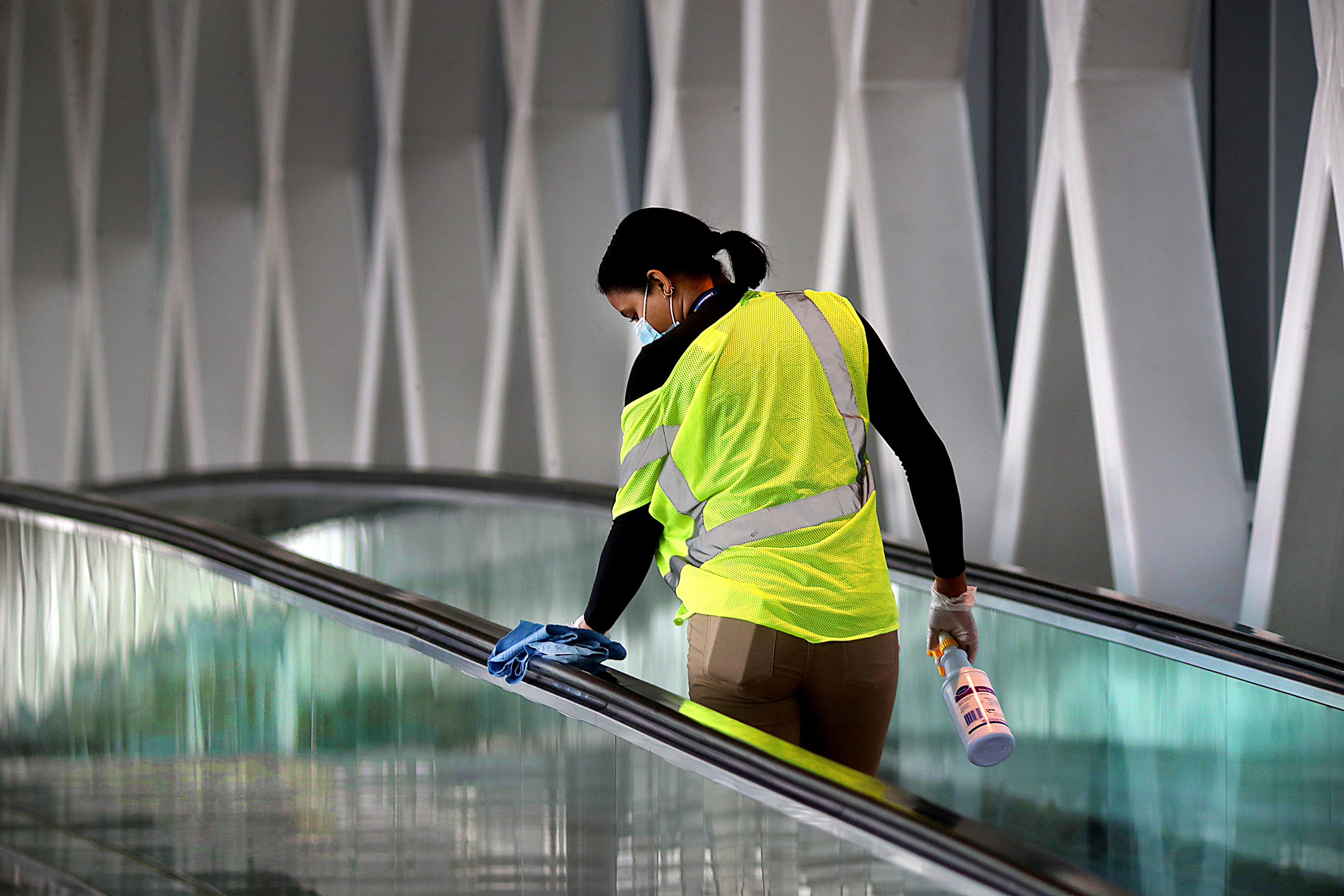 A worker cleaned a railing on a walkway leading to Terminal A at Logan Airport.