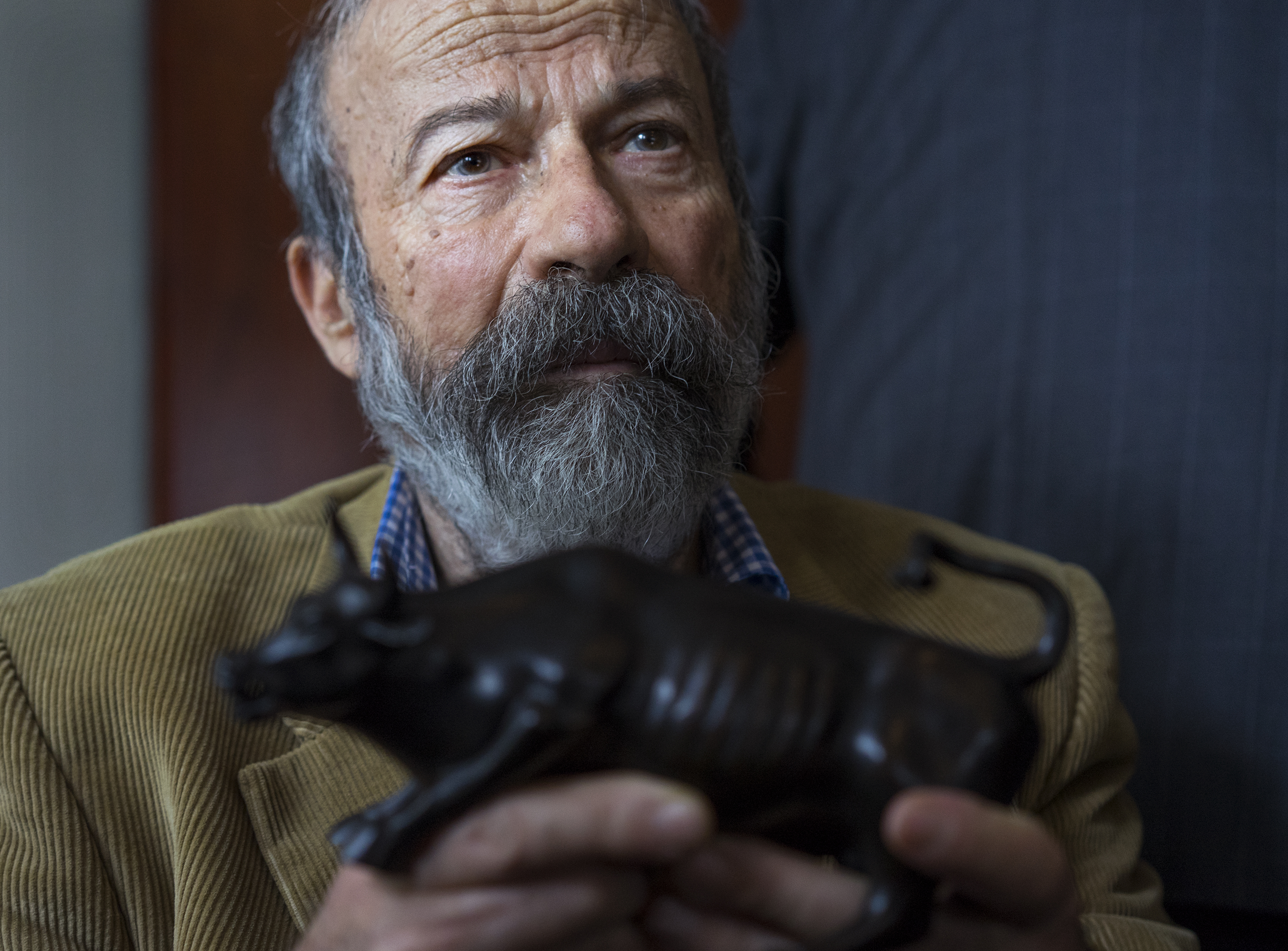 Arturo Di Modica held a model of his “Charging Bull” sculpture.