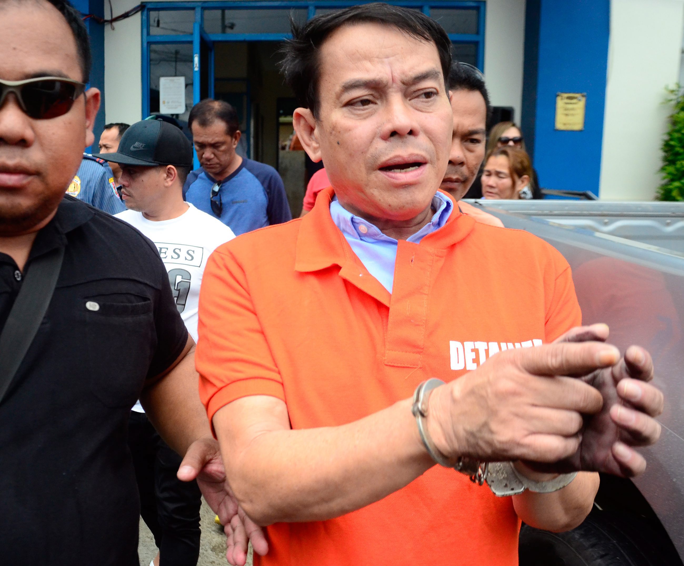 Rolando Espinosa Sr., mayor of Albuera Township, was escorted by officers following his arrest in the Philippines in October.