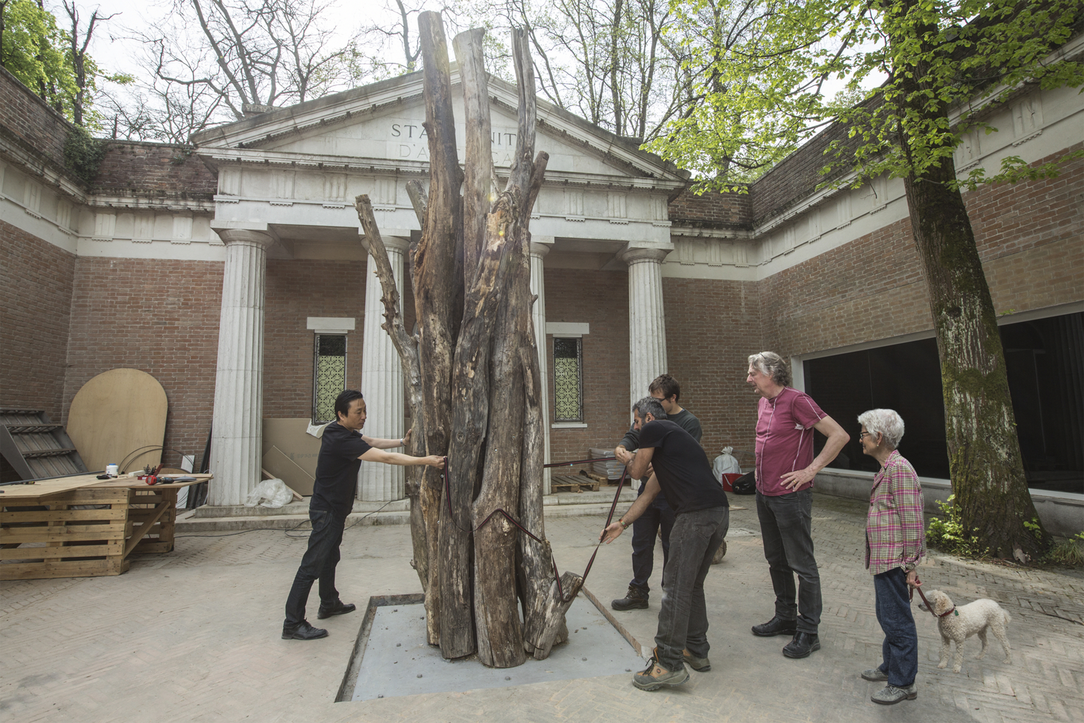 Joan Jonas (right) watched a team of workers placing pieces in the forecourt of the US Pavilion at the Venice Biennale.